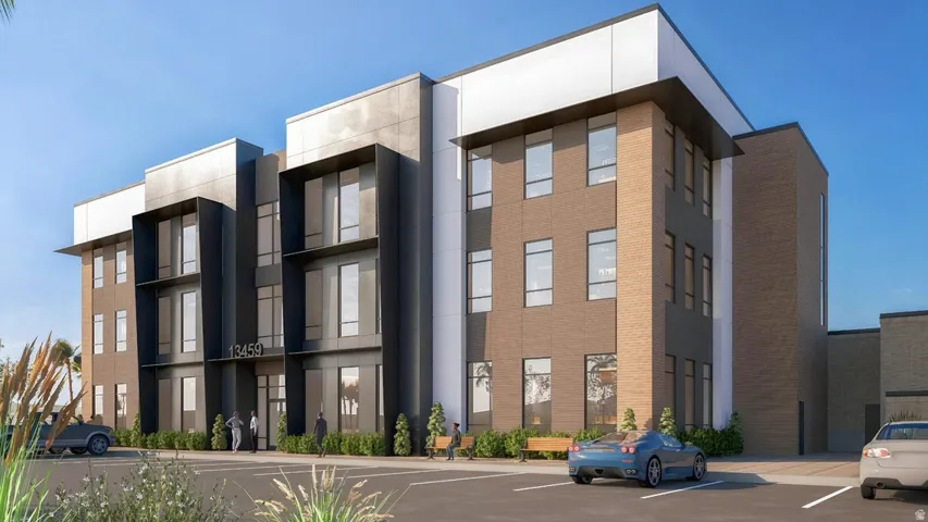 View of apartment building / complex with uncovered parking