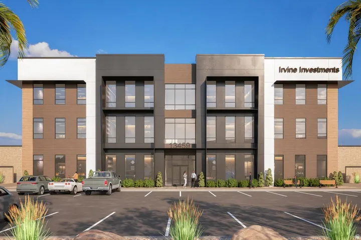 View of building exterior with uncovered parking