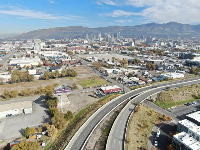 Aerial overview of property's location with a mountain backdrop and nearby urban area