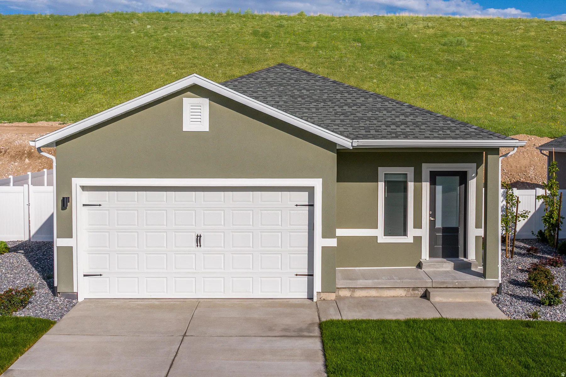 Ranch-style home featuring stucco siding, a garage, concrete driveway, and roof with shingles