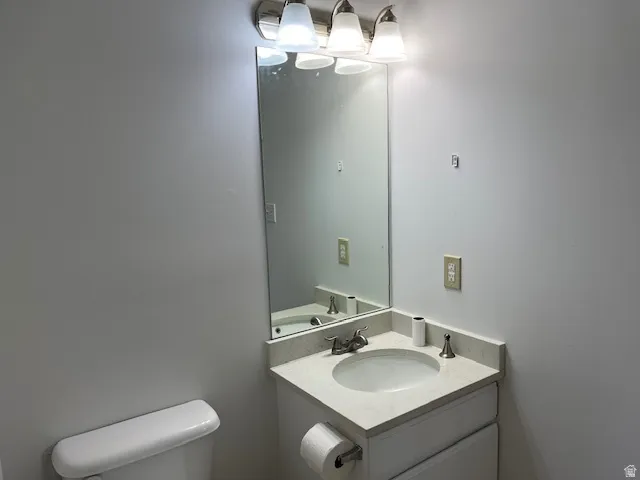 Half bath featuring vanity and toilet