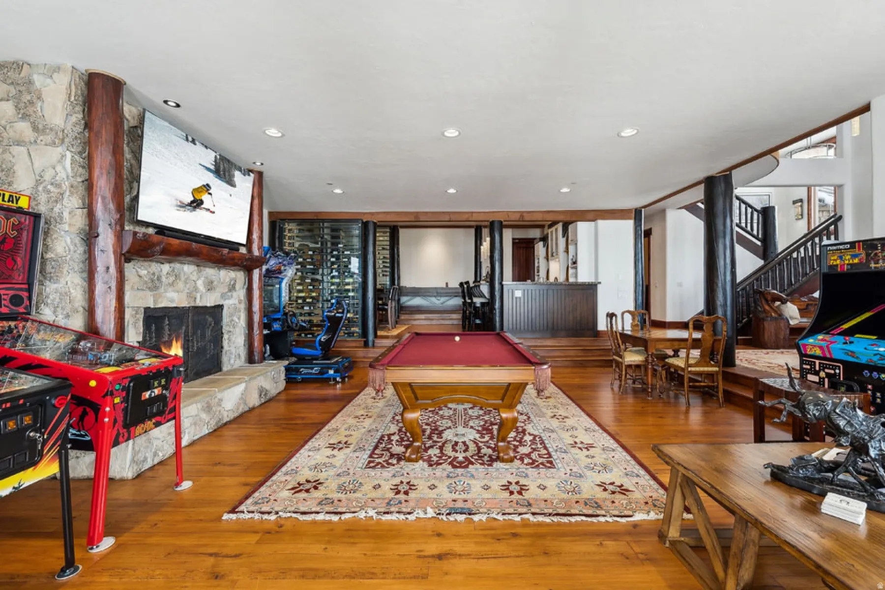 Rec room featuring pool table, a fireplace, hardwood / wood-style flooring, and recessed lighting