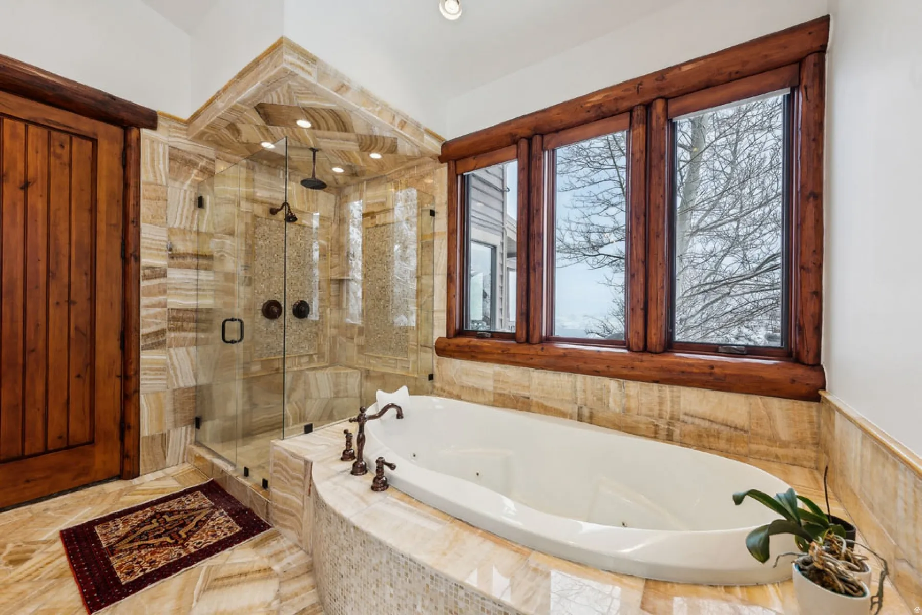 Bathroom with a stall shower and a jetted tub