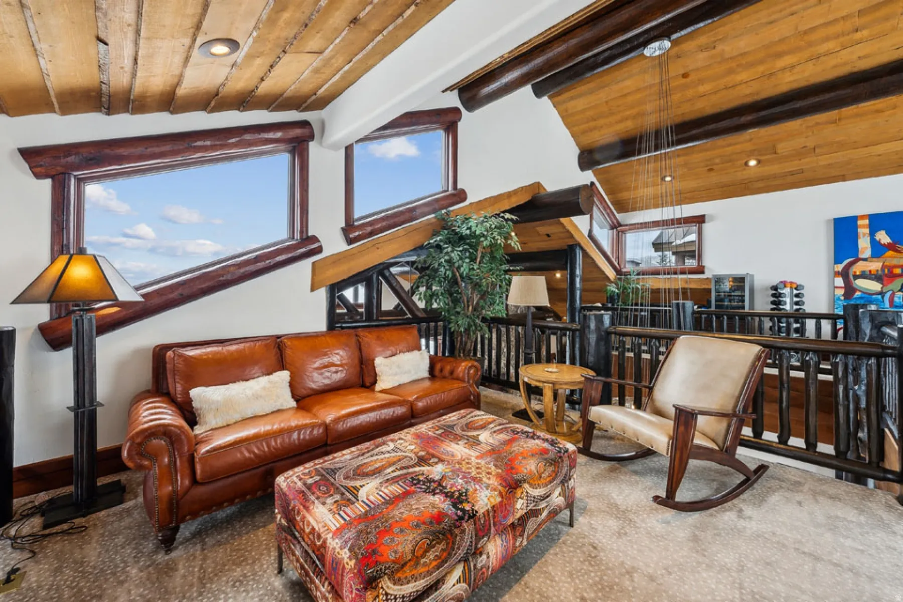 Living room with a high wood beamed ceiling and recessed lighting