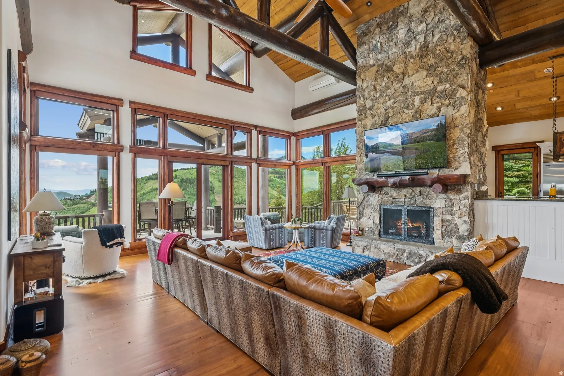 Living area featuring a fireplace, a high wooden beamed ceiling, and wood-type flooring