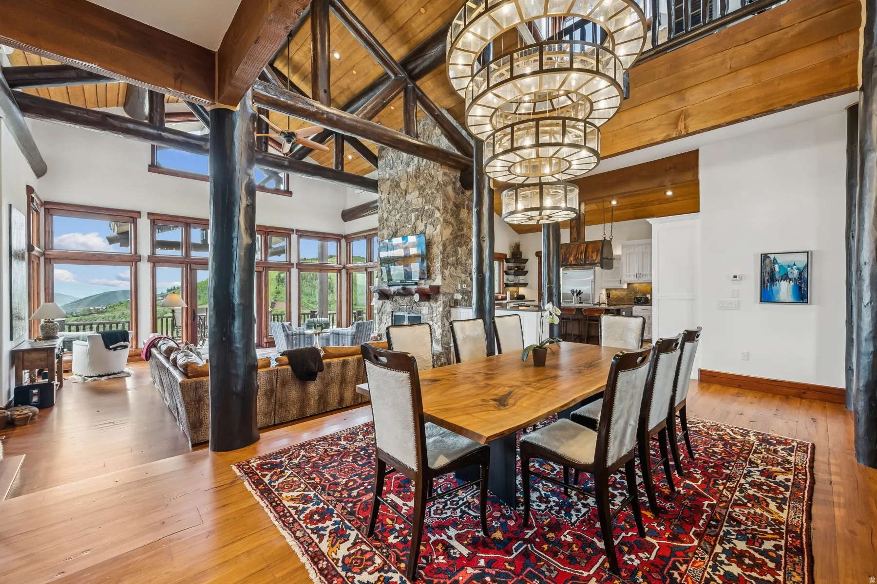 Dining room featuring light wood-type flooring and a high wooden beamed ceiling