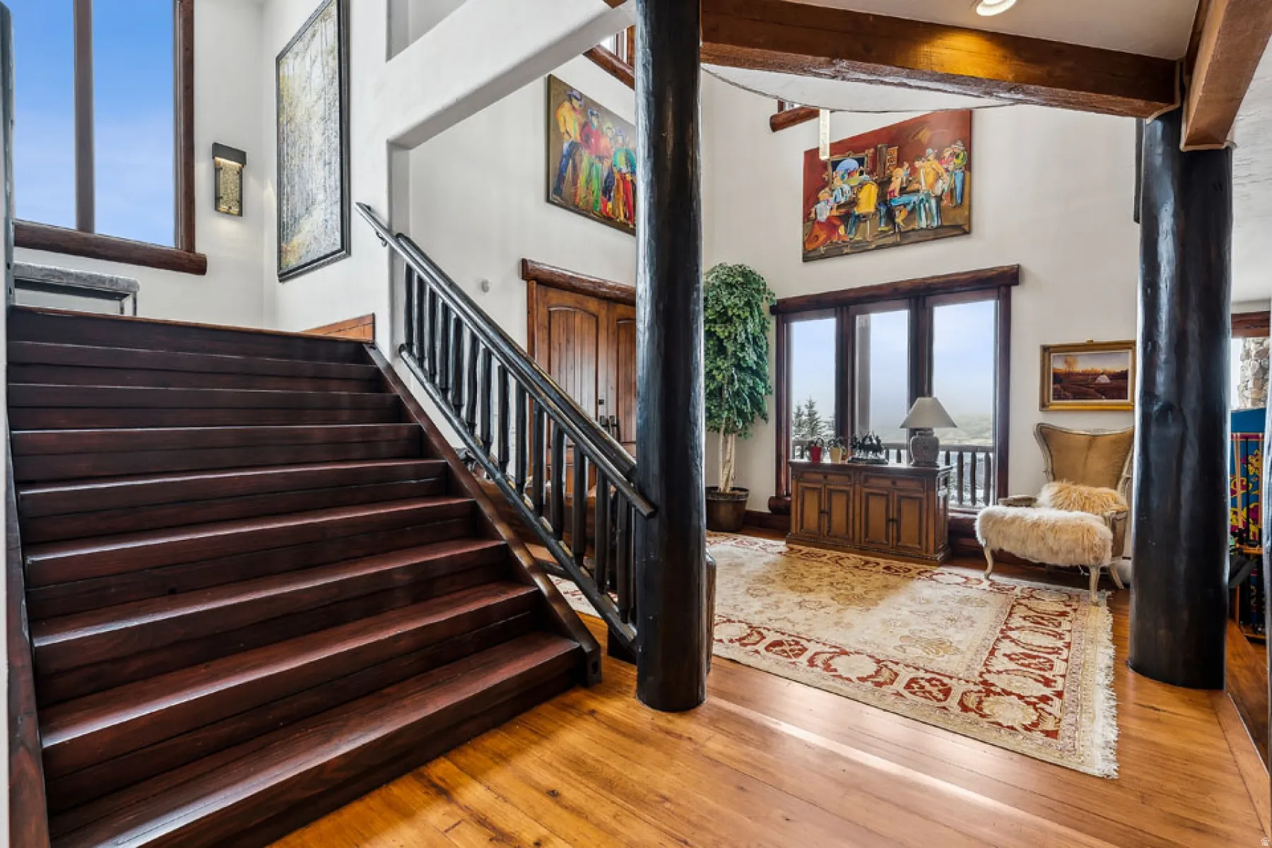 Stairway featuring hardwood / wood-style floors
