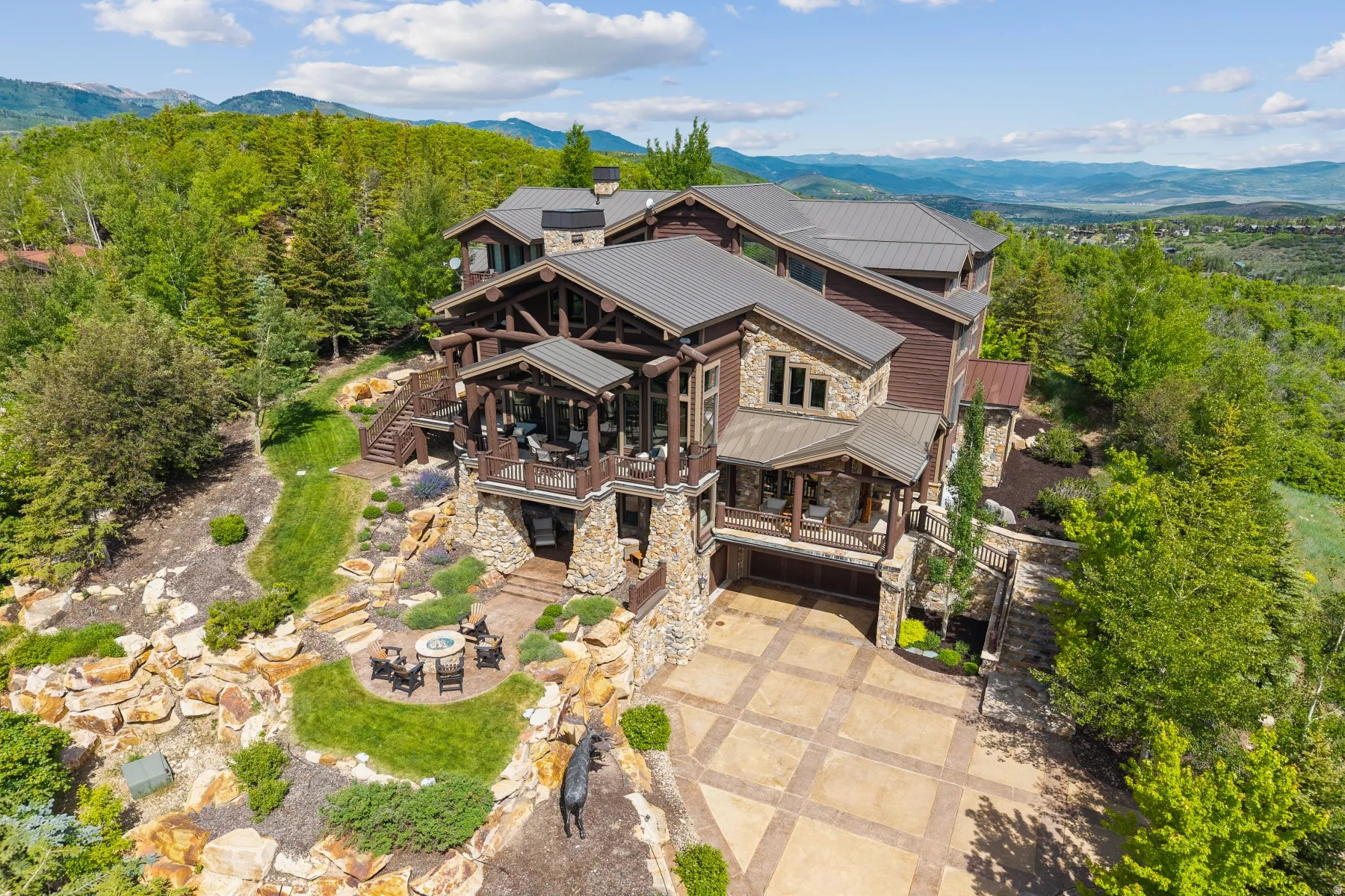 Aerial view of property and surrounding area featuring mountains