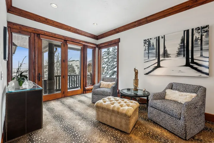 Living area featuring french doors, ornamental molding, and recessed lighting