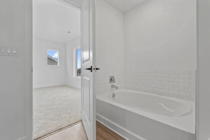 Bathtub with subway tile surround and chrome fixtures
