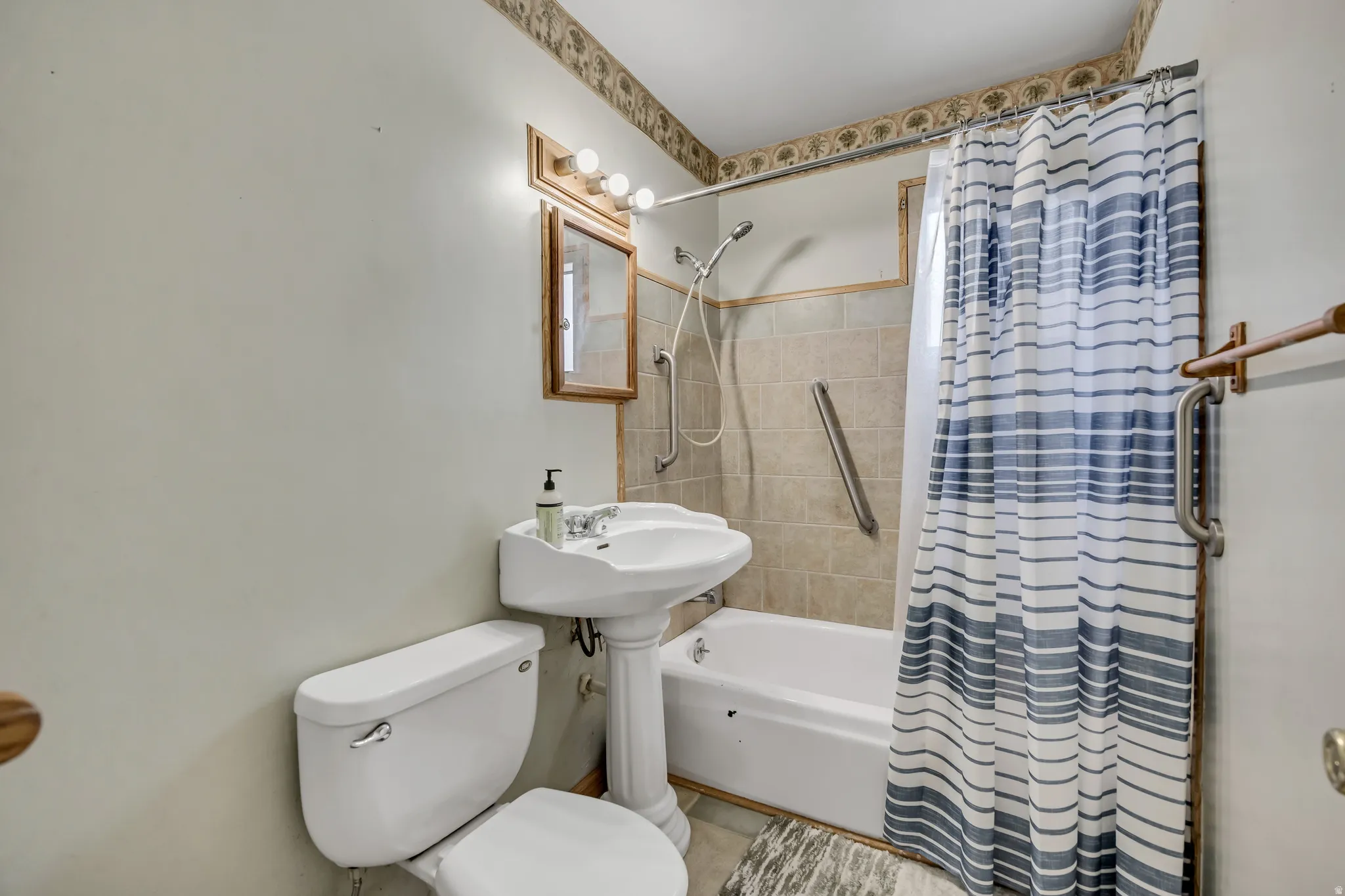 Bathroom with shower / bathtub combination with curtain and toilet