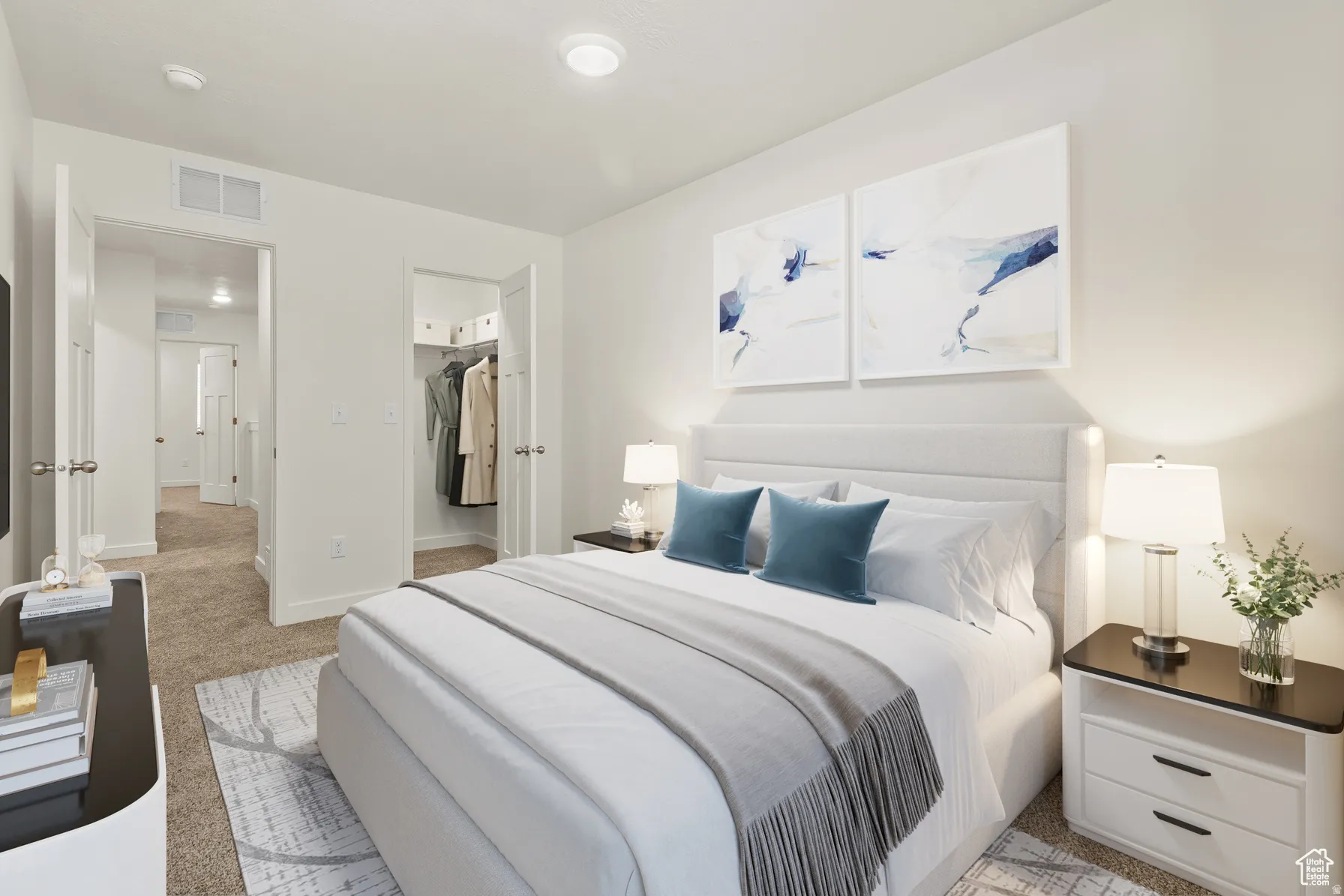 Bedroom with a walk in closet and light carpet