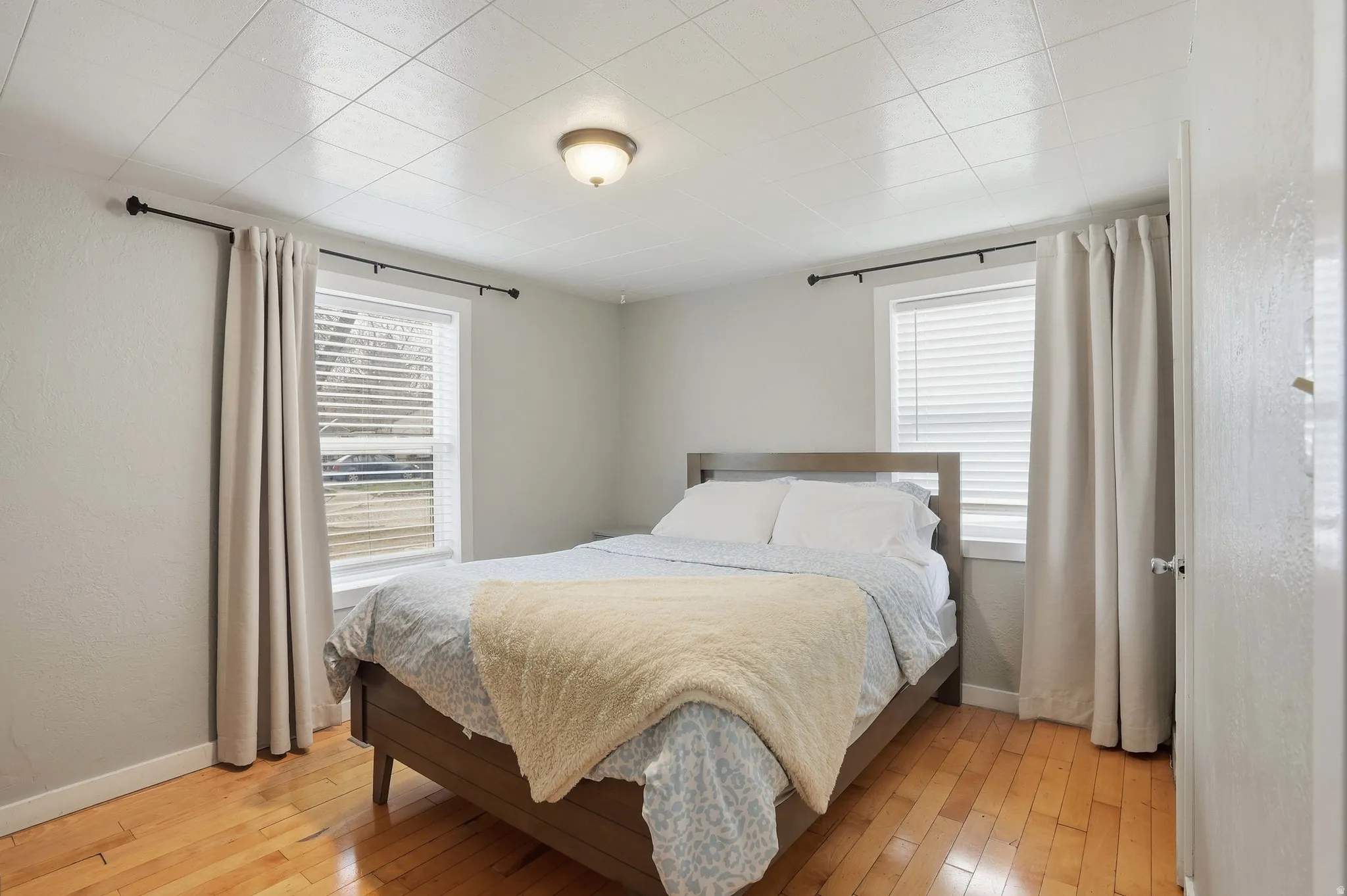 Bedroom featuring light wood-style flooring and baseboards