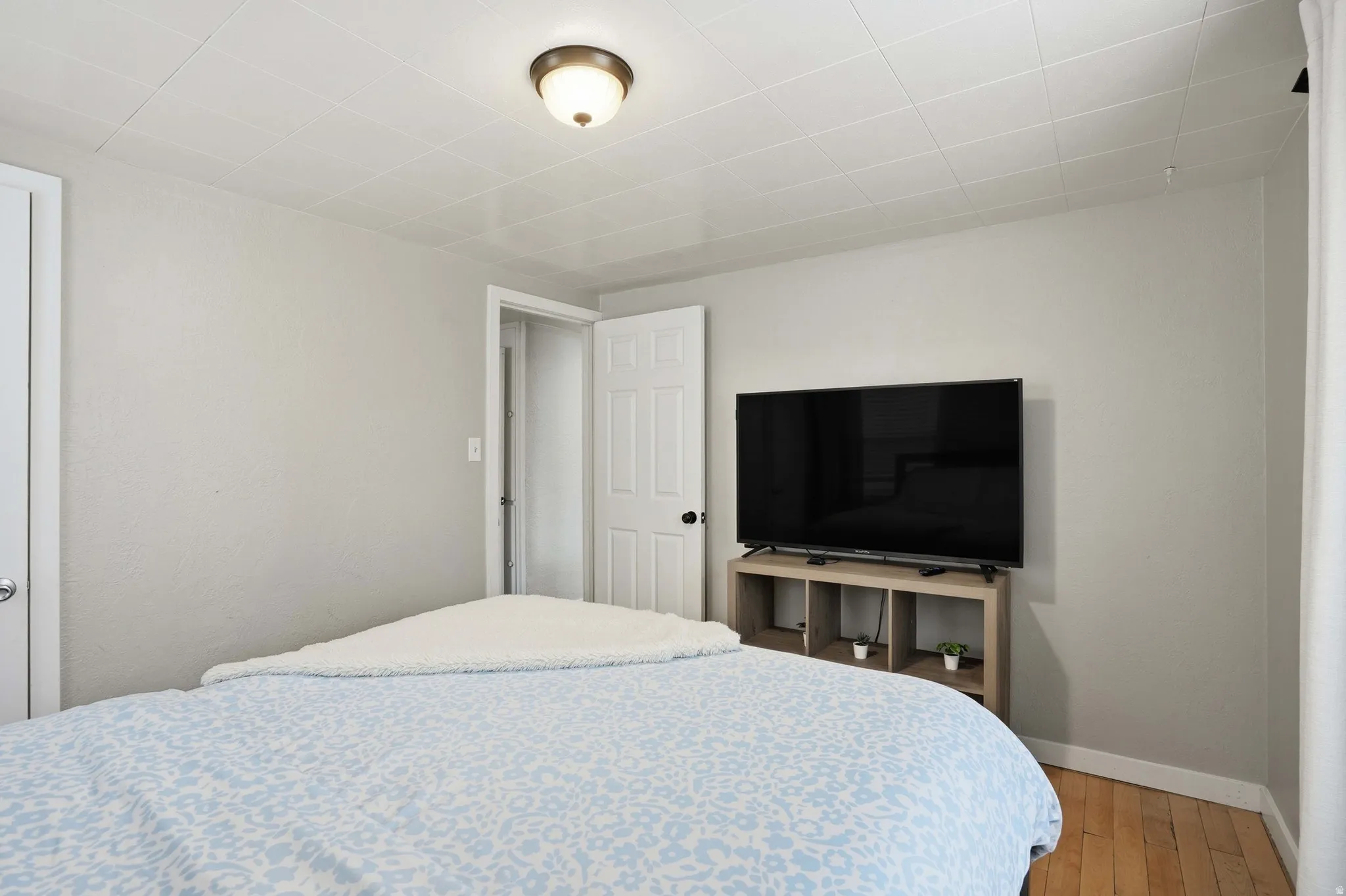 Bedroom with baseboards and light wood-style flooring