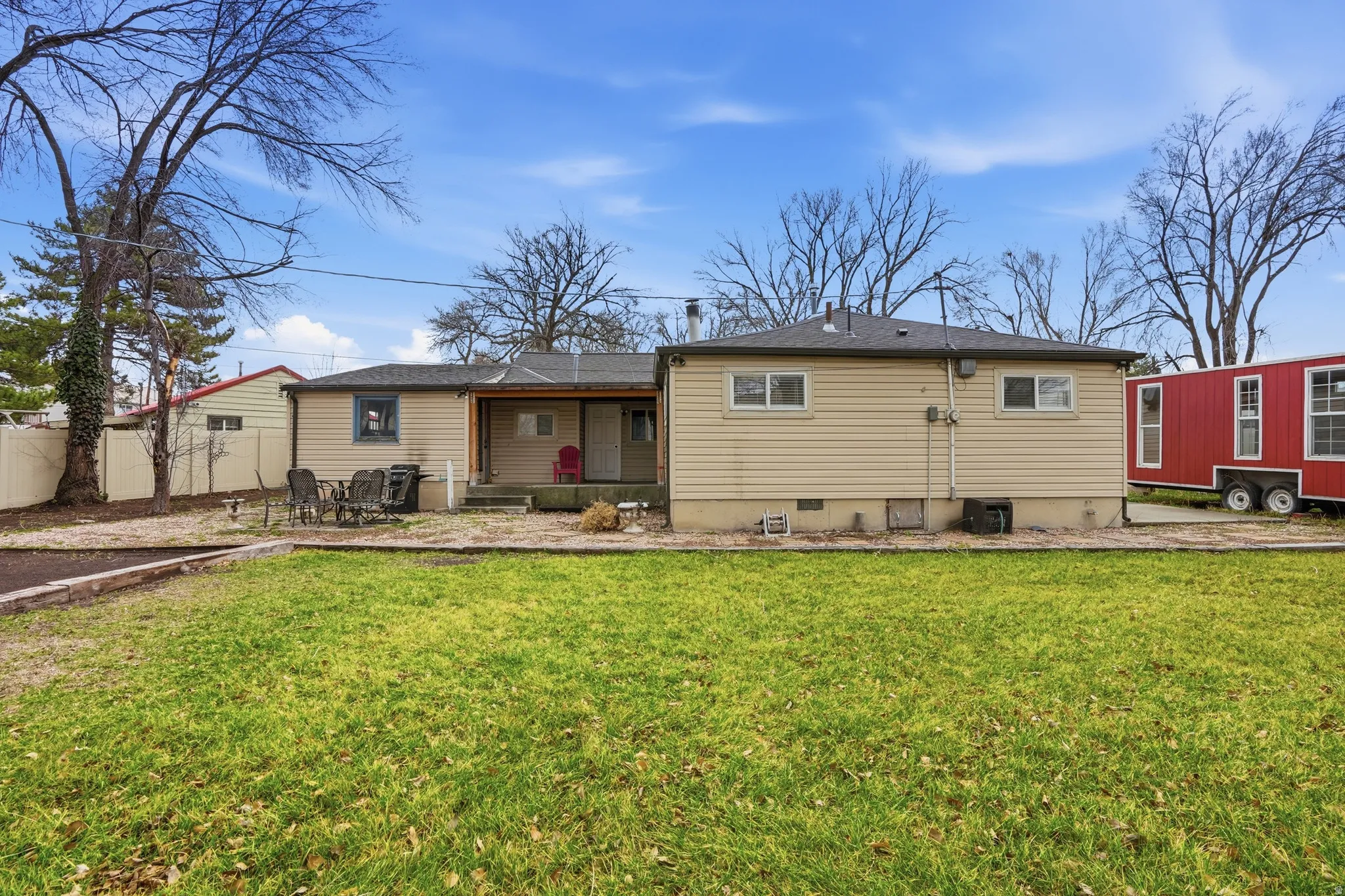 Back of house with a patio, roof with shingles, and crawl space