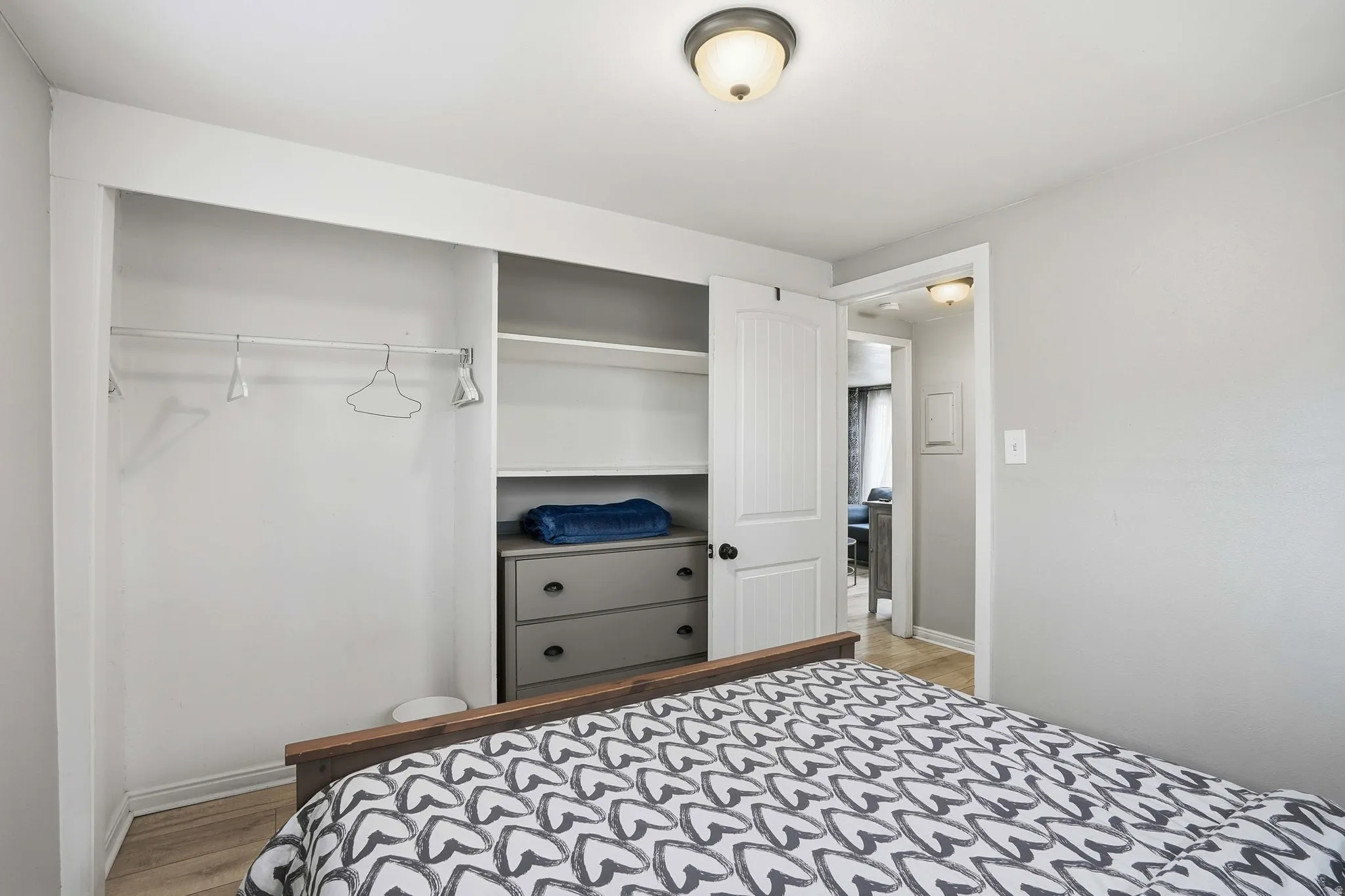 Bedroom featuring a closet and light wood-style flooring