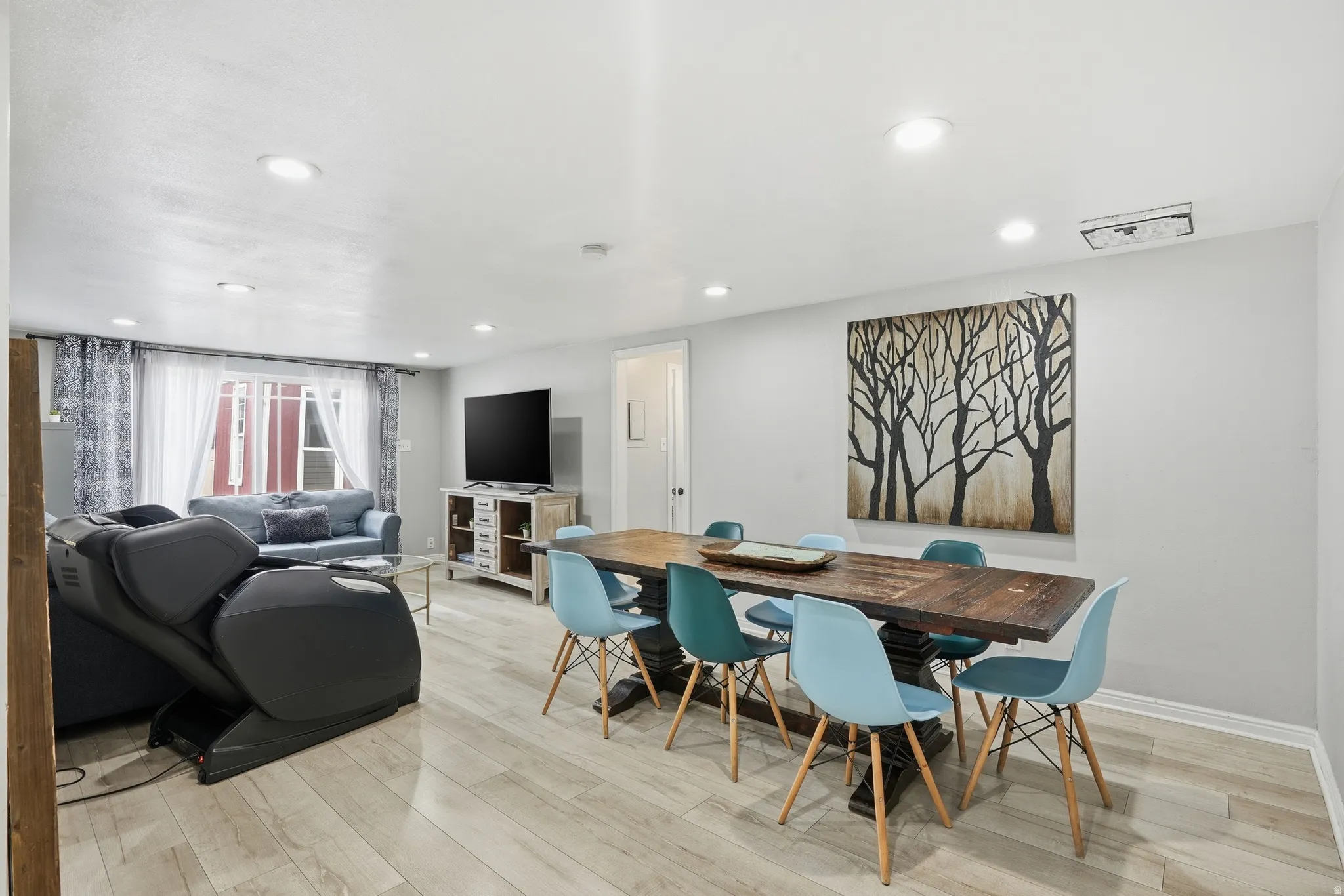 Dining space with light wood-style floors and recessed lighting