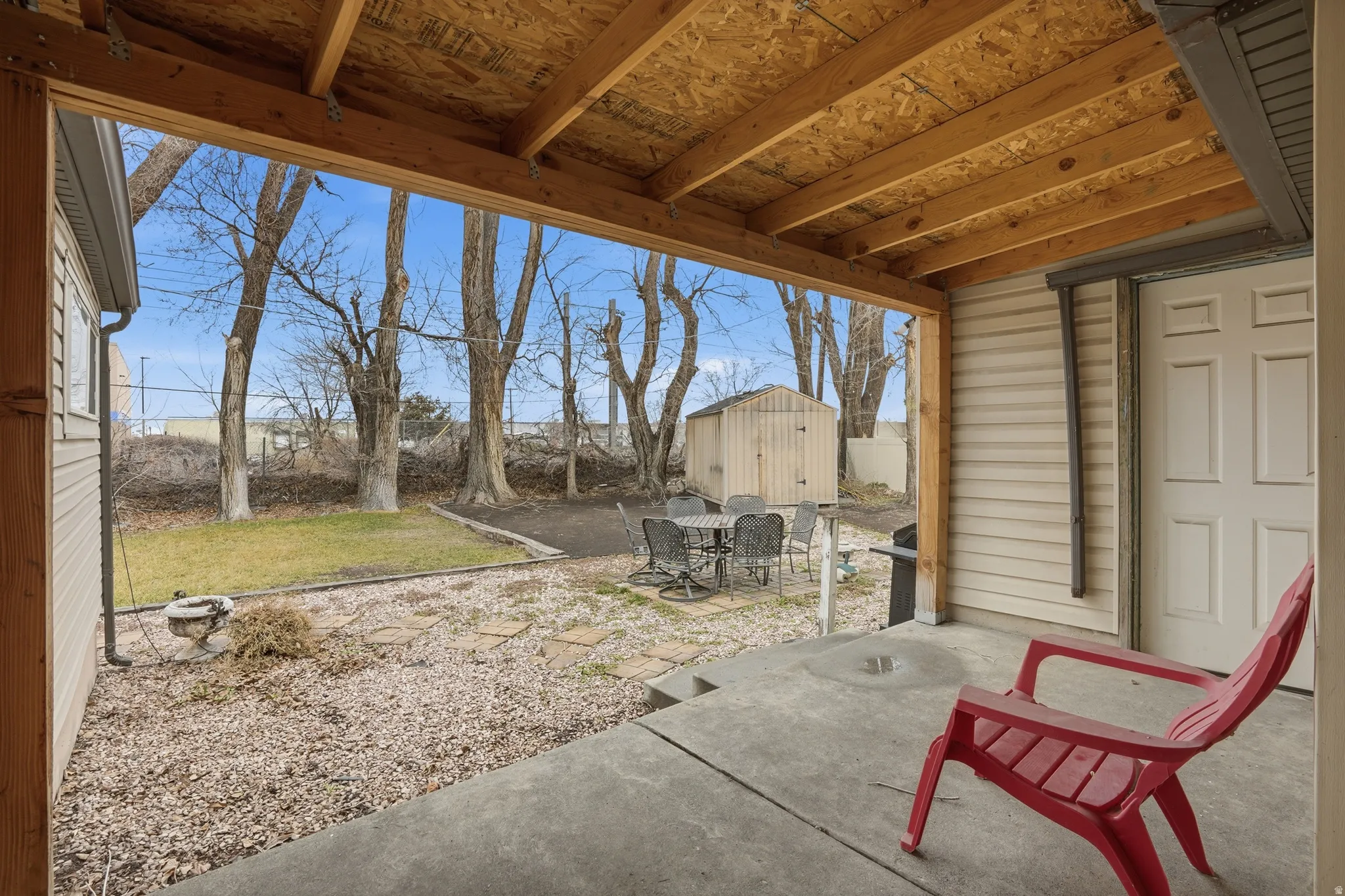 View of patio featuring outdoor dining space and a shed