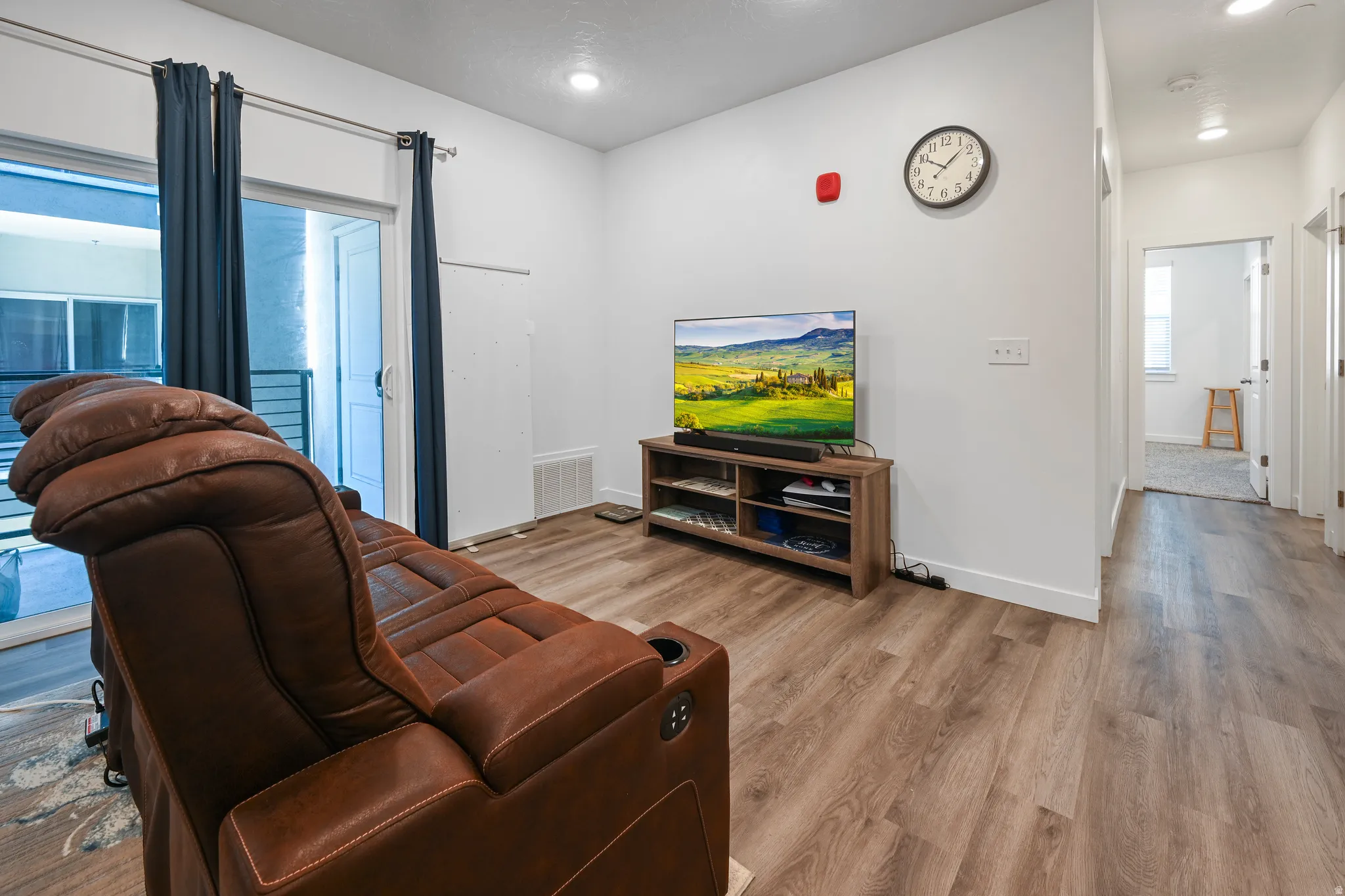 Living area with light wood-style floors and baseboards