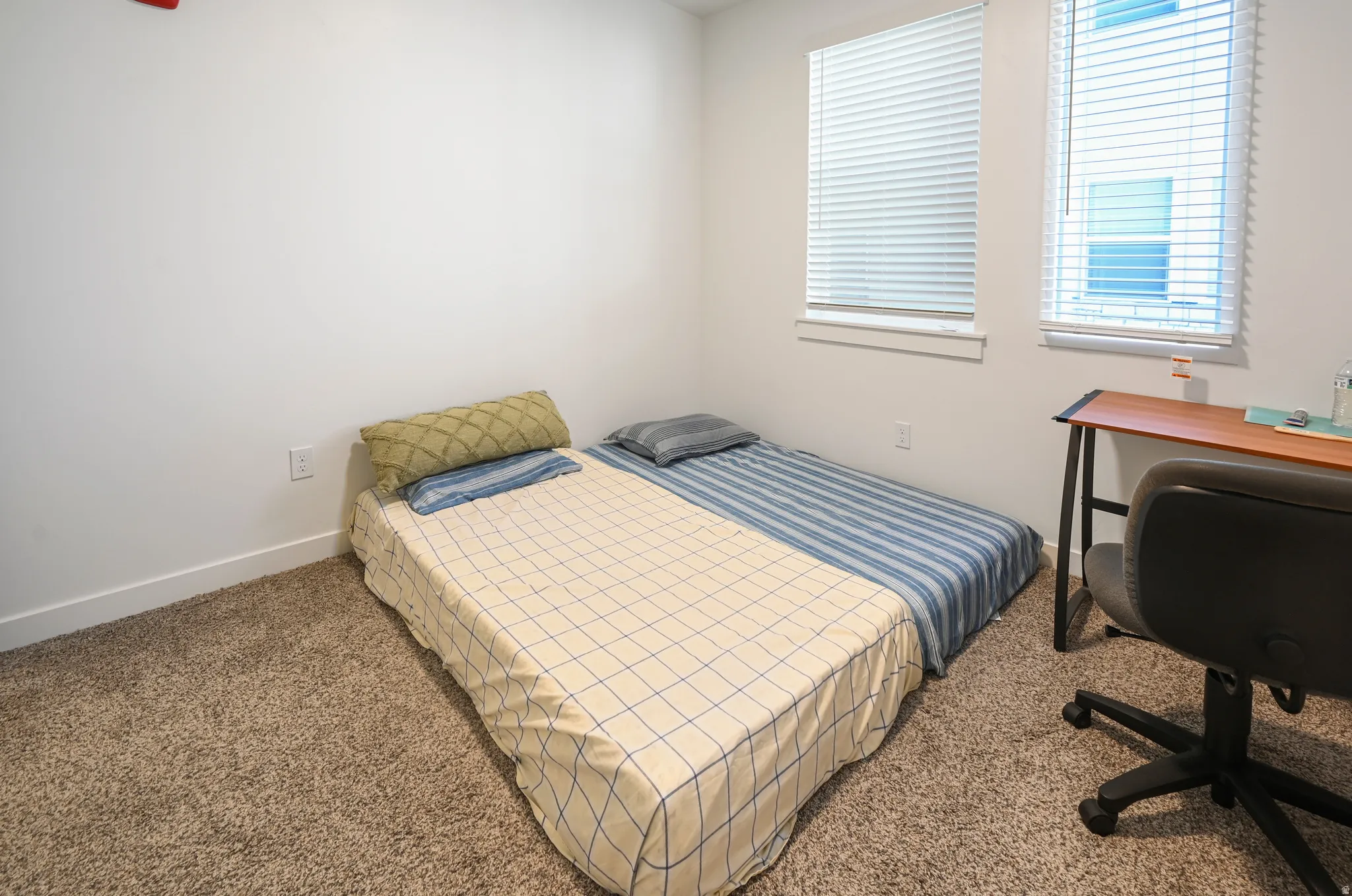 Bedroom featuring carpet floors and baseboards