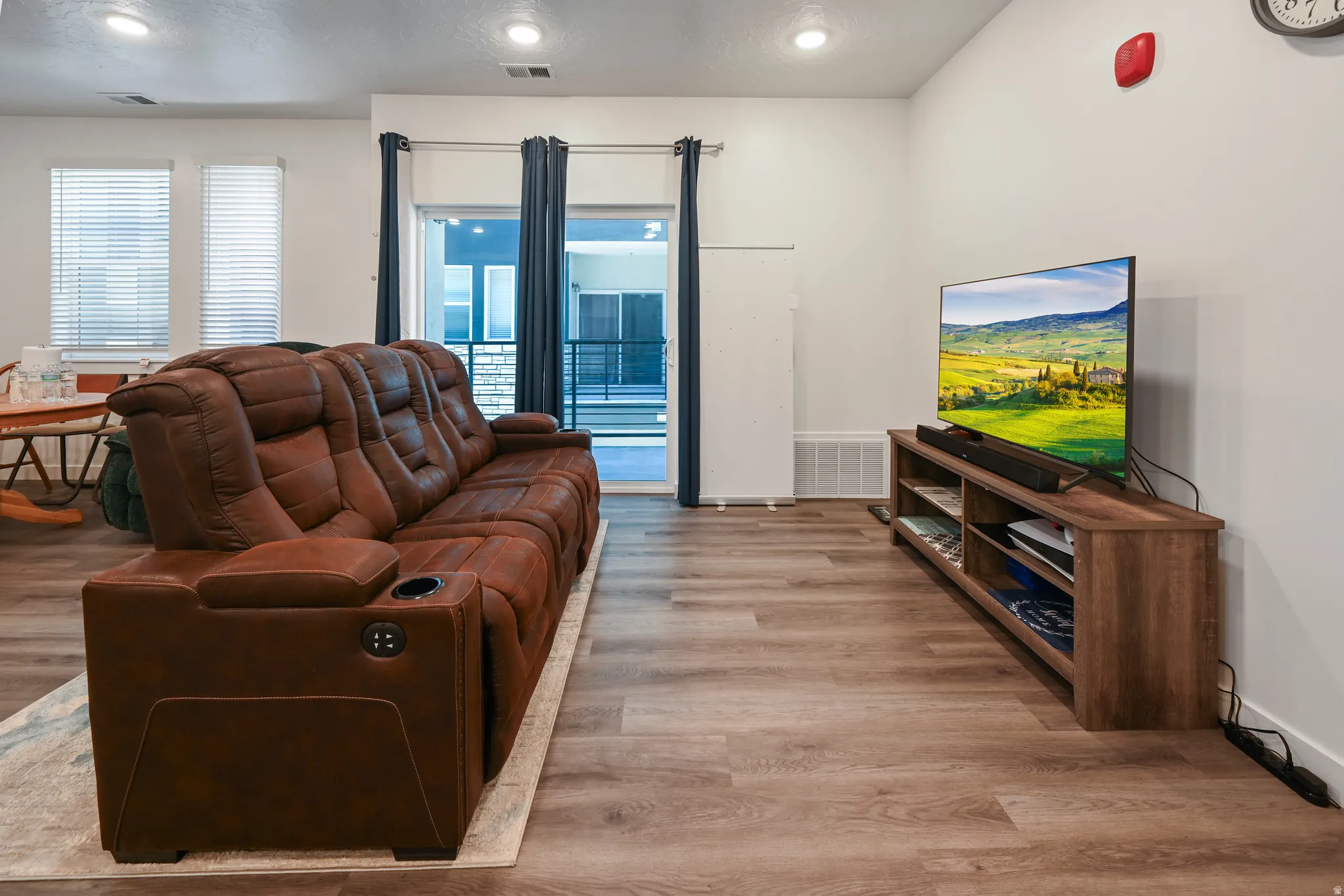 Living room featuring light wood finished floors, healthy amount of natural light, and recessed lighting