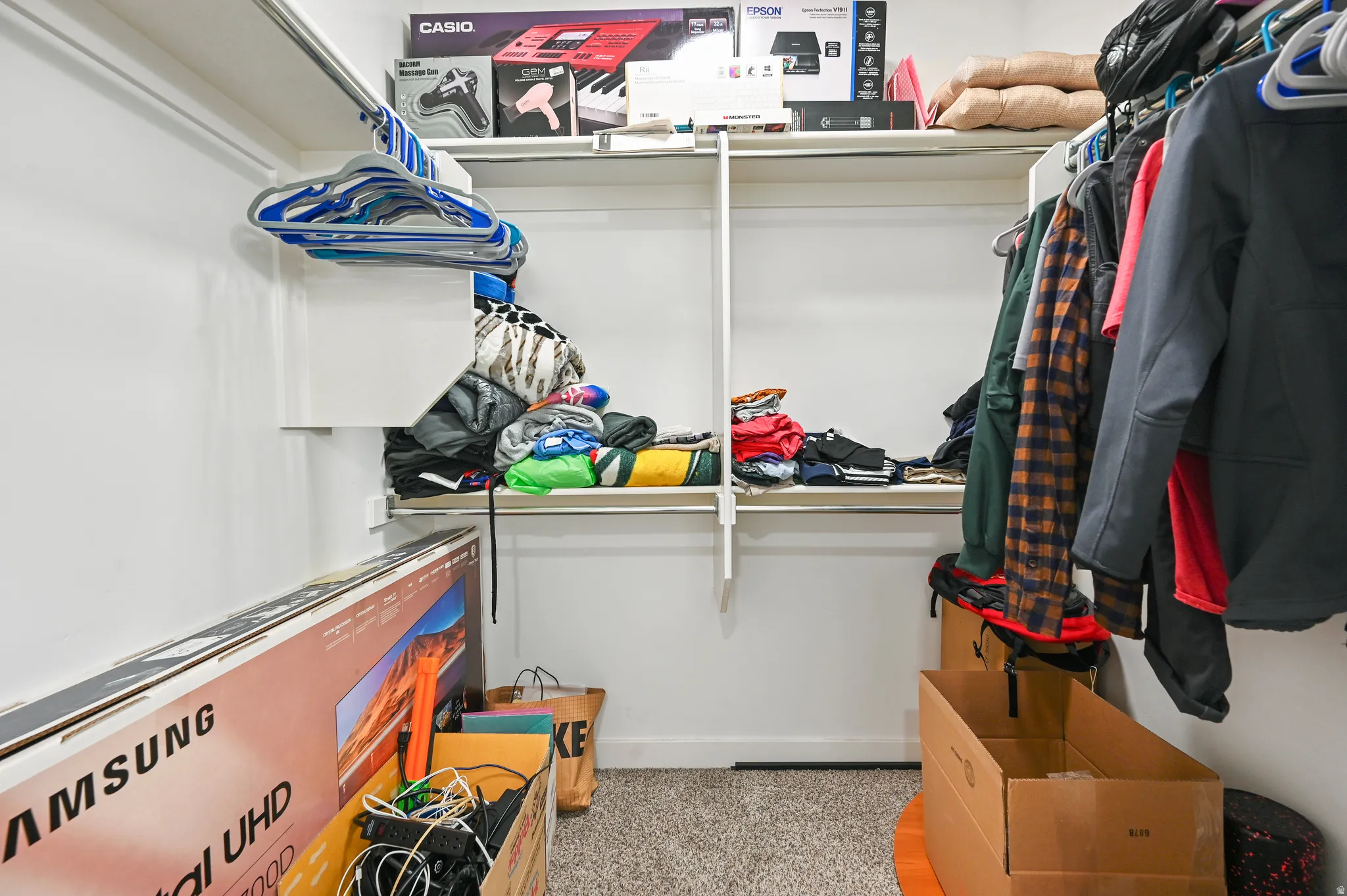Walk in closet with light carpet