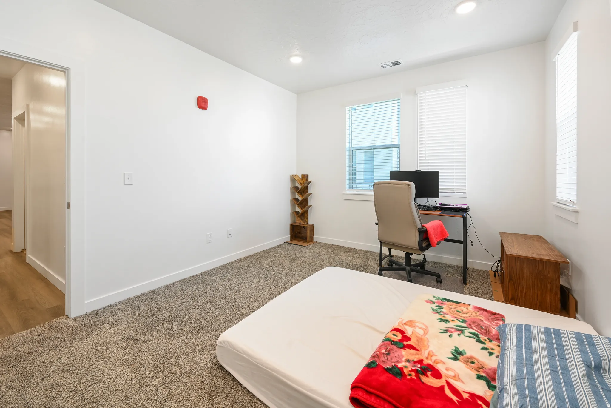 Carpeted bedroom featuring recessed lighting and an office area