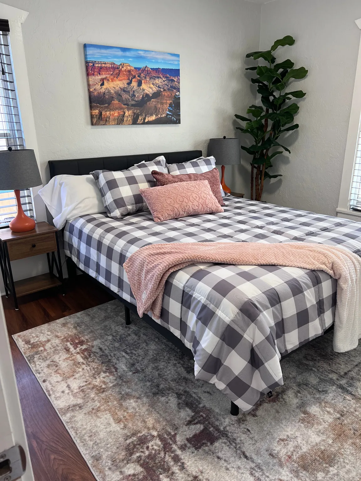 Bedroom featuring dark wood-type flooring and a textured wall