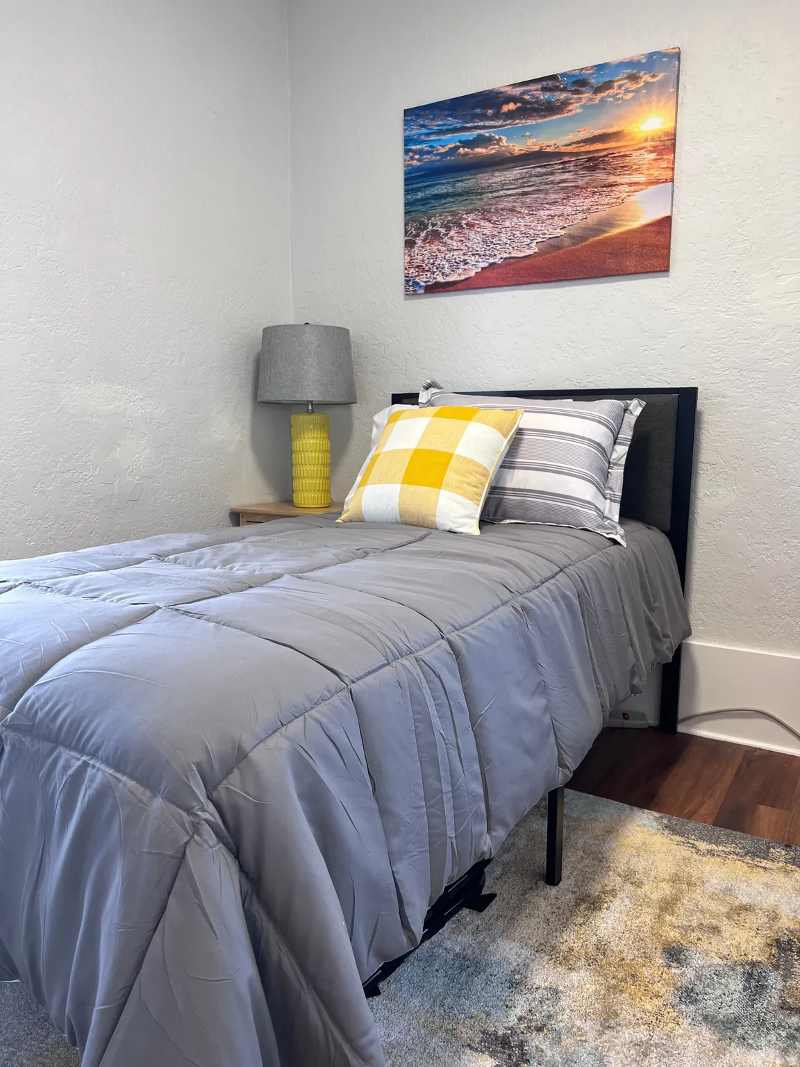Bedroom featuring a textured wall and wood finished floors
