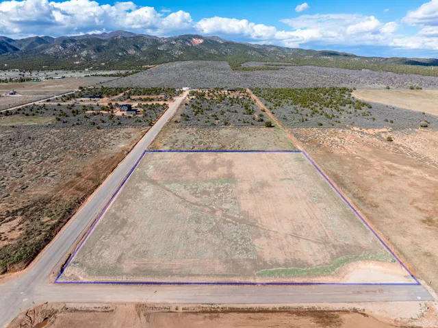 View of rural area featuring a mountainous background and property parcel outlined