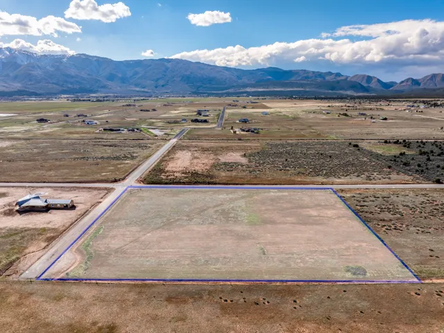 Aerial view of sparsely populated area featuring mountains and property boundaries highlighted