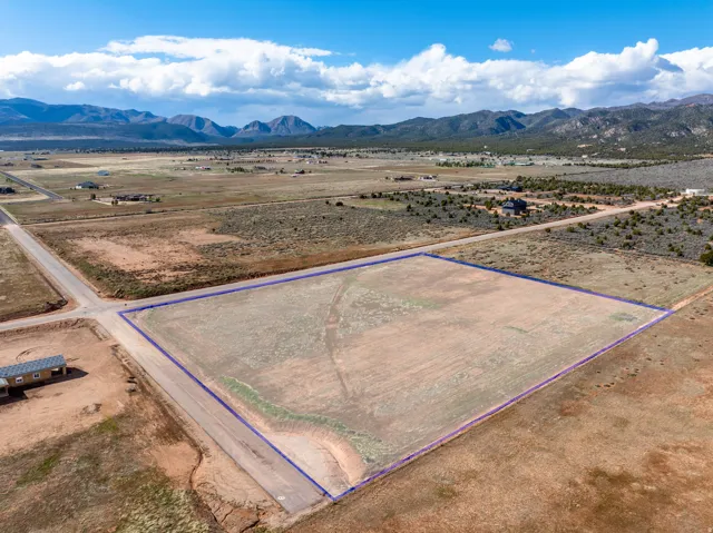 View of rural area with property boundaries highlighted and a mountainous background
