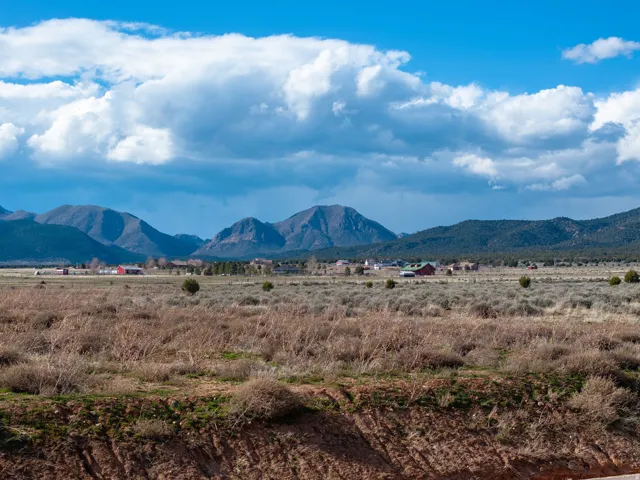 View of mountain backdrop featuring rural landscape