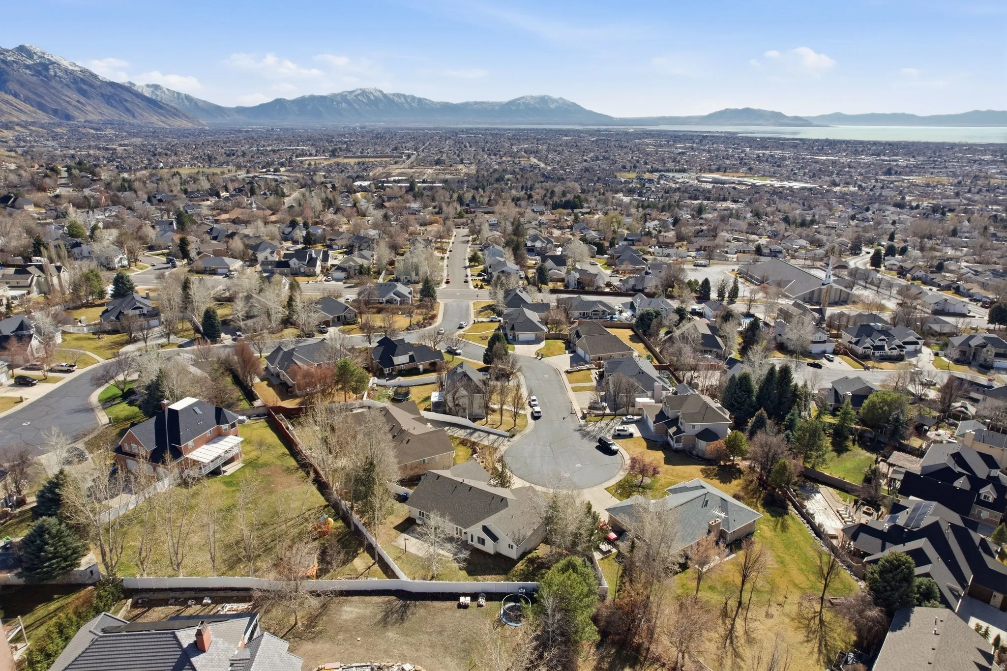 Aerial perspective of suburban area with a mountainous background