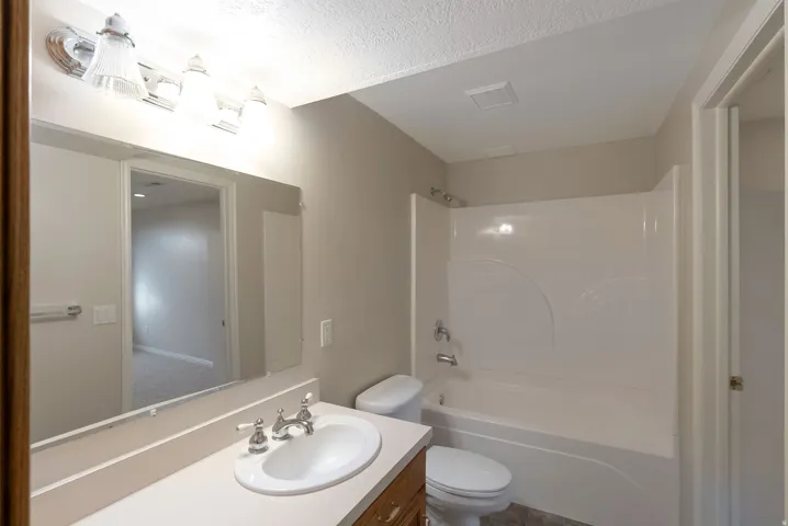 Bathroom featuring vanity and shower / bathtub combination
