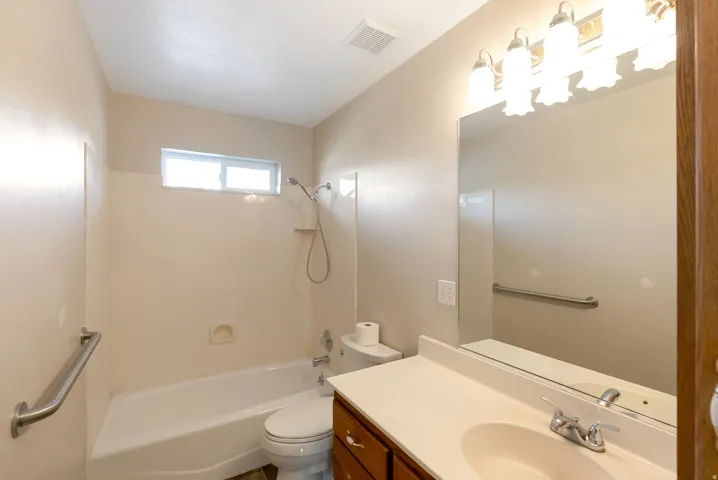 Full bath featuring vanity and shower/tub combination
