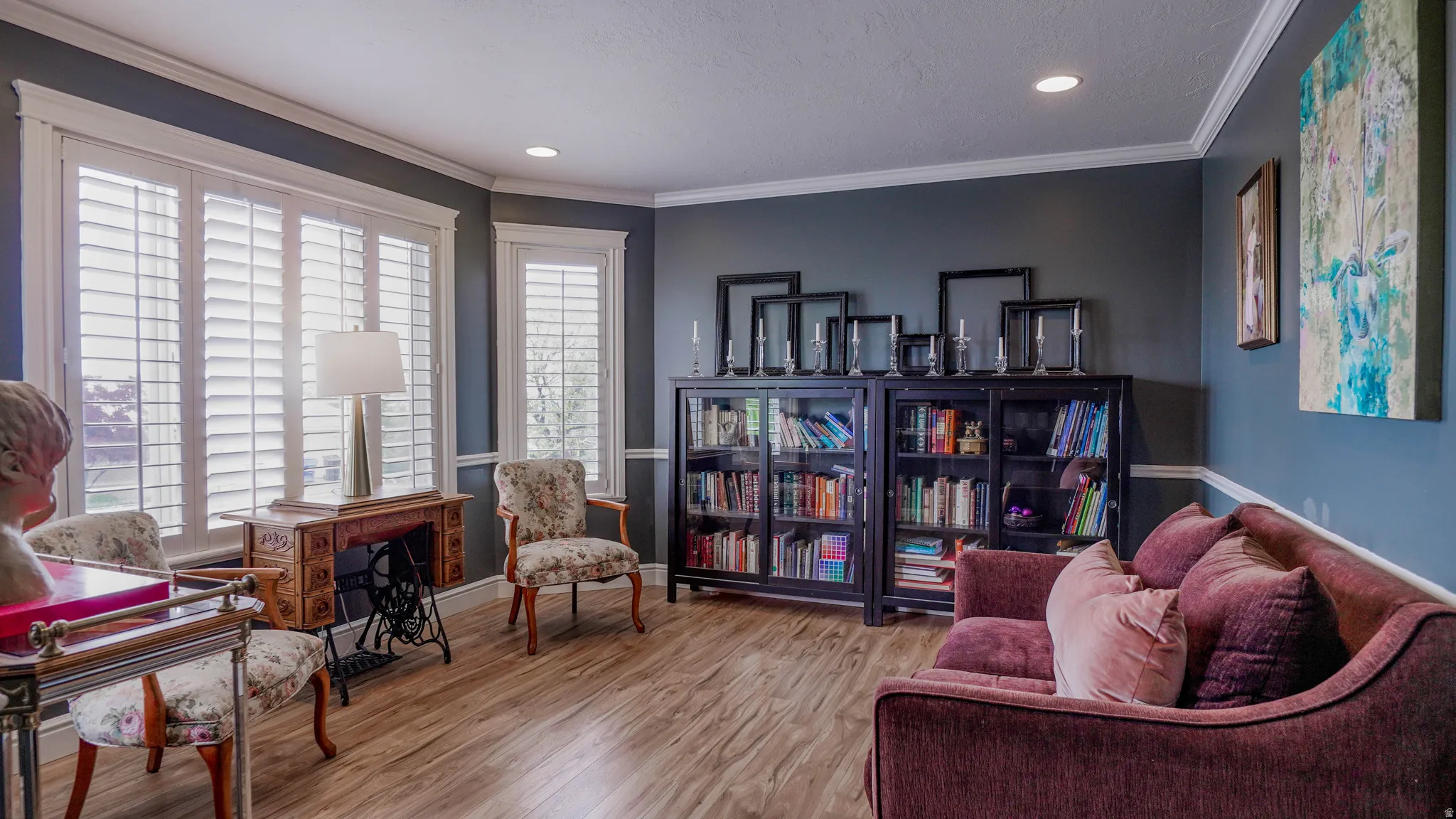Sitting room with wood finished floors, recessed lighting, and ornamental molding
