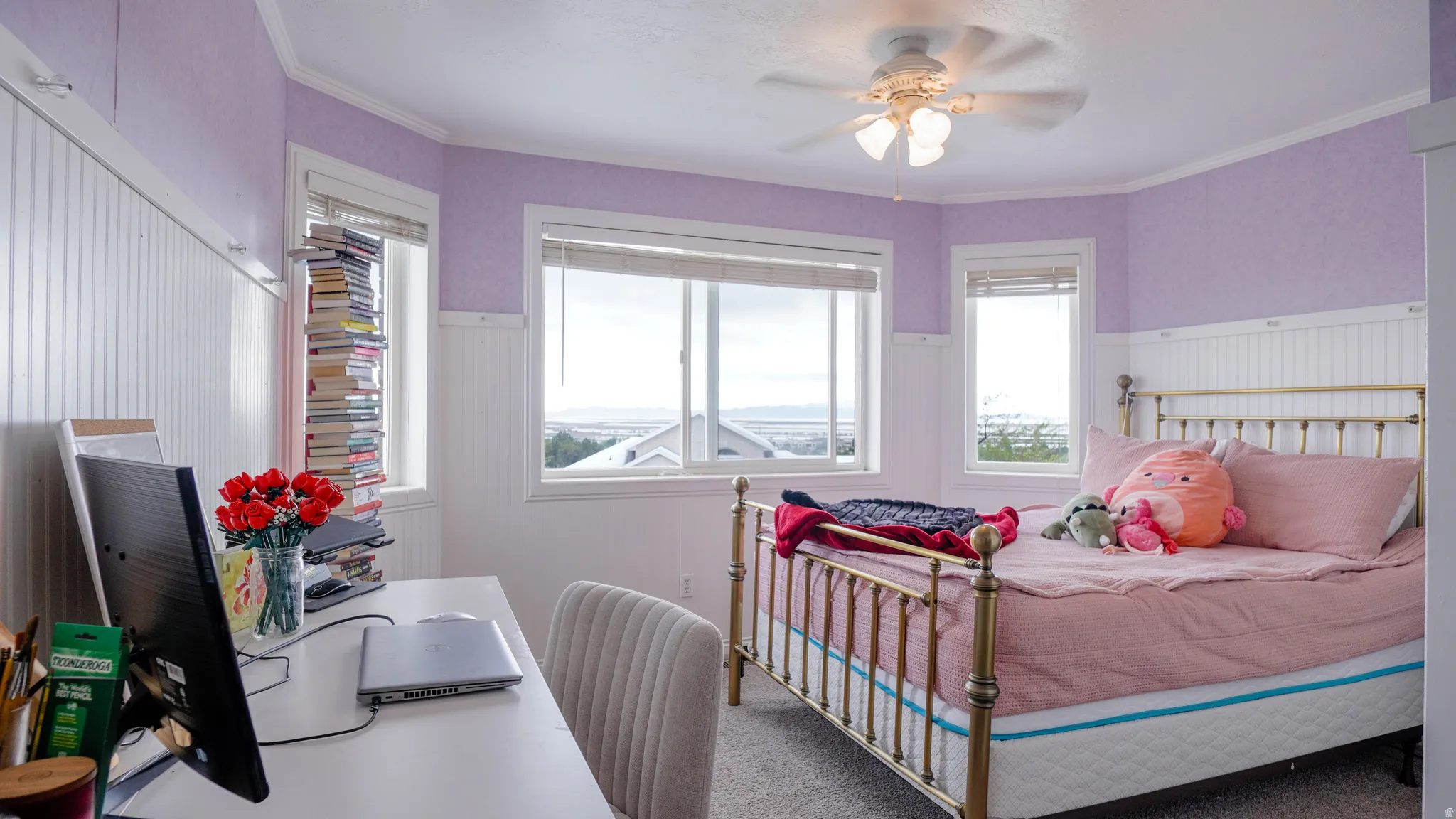 Bedroom featuring carpet, a wainscoted wall, ceiling fan, and ornamental molding