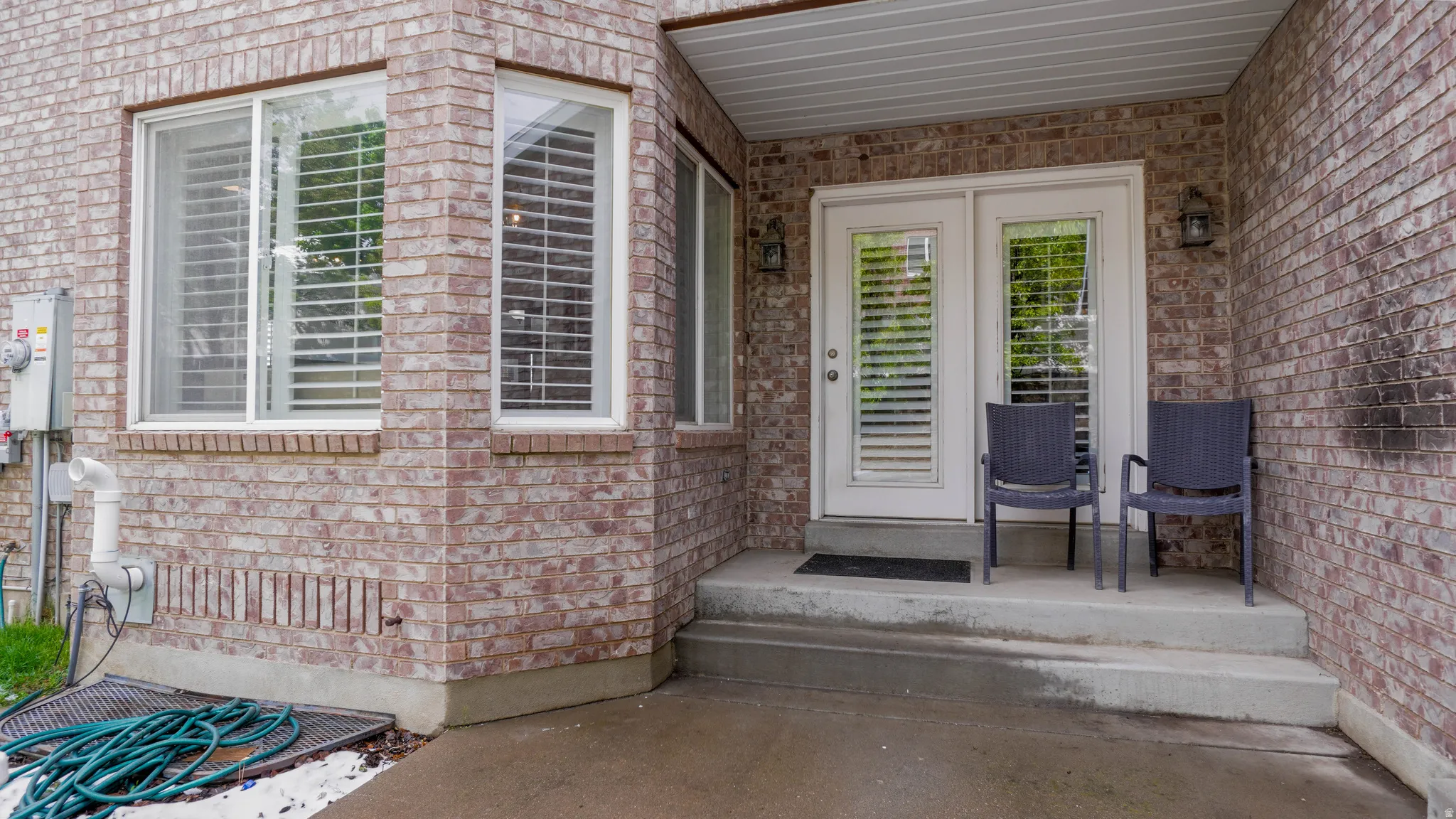 View of exterior entry with brick siding