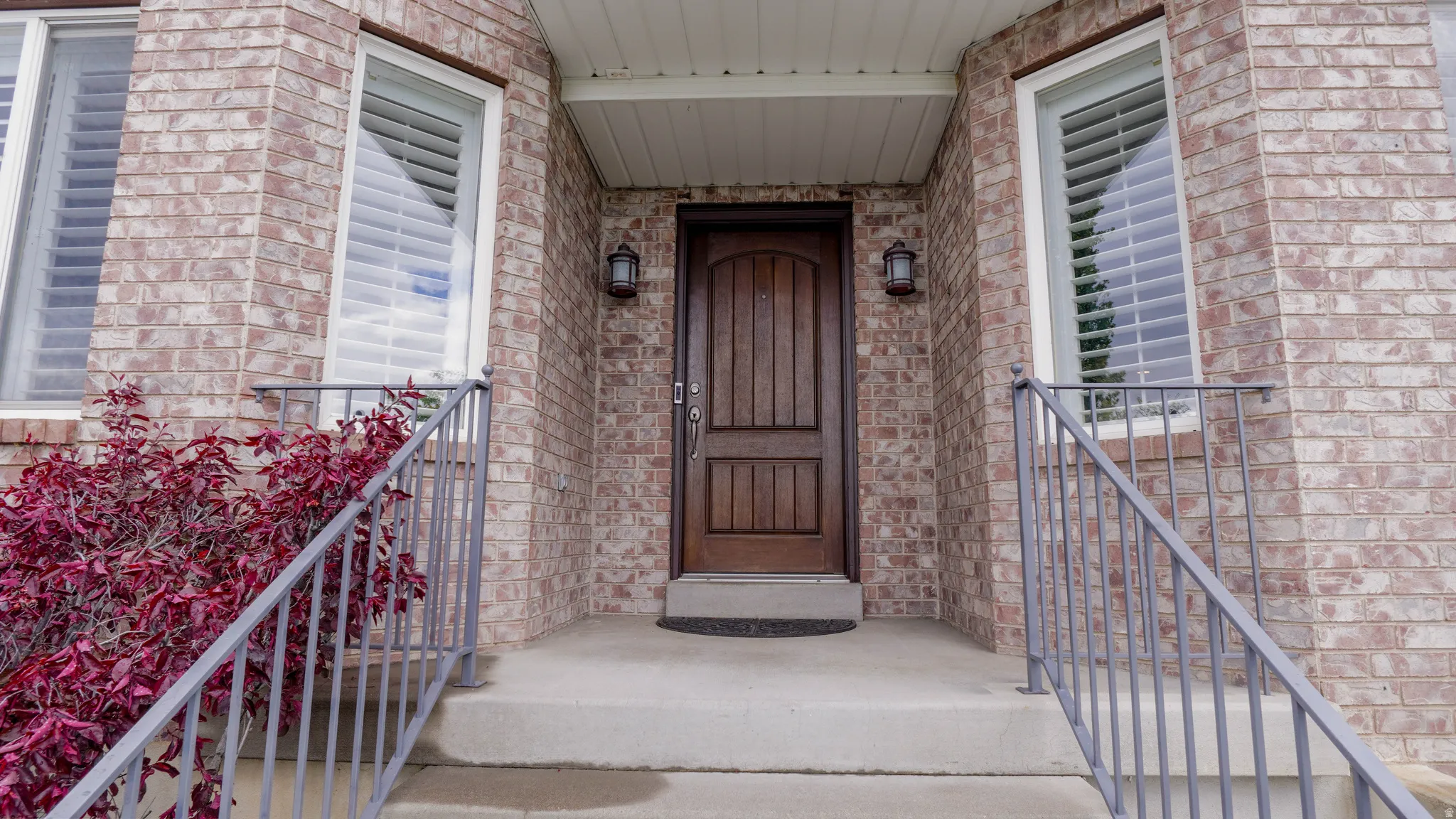 View of exterior entry featuring brick siding