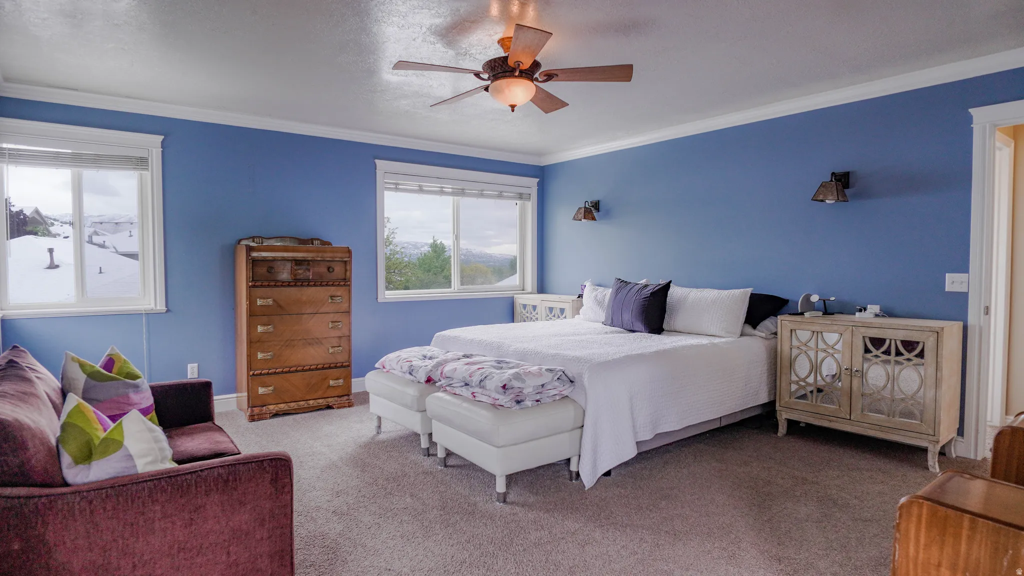 Large Primary Bedroom featuring Lots of Natural Light and crown molding