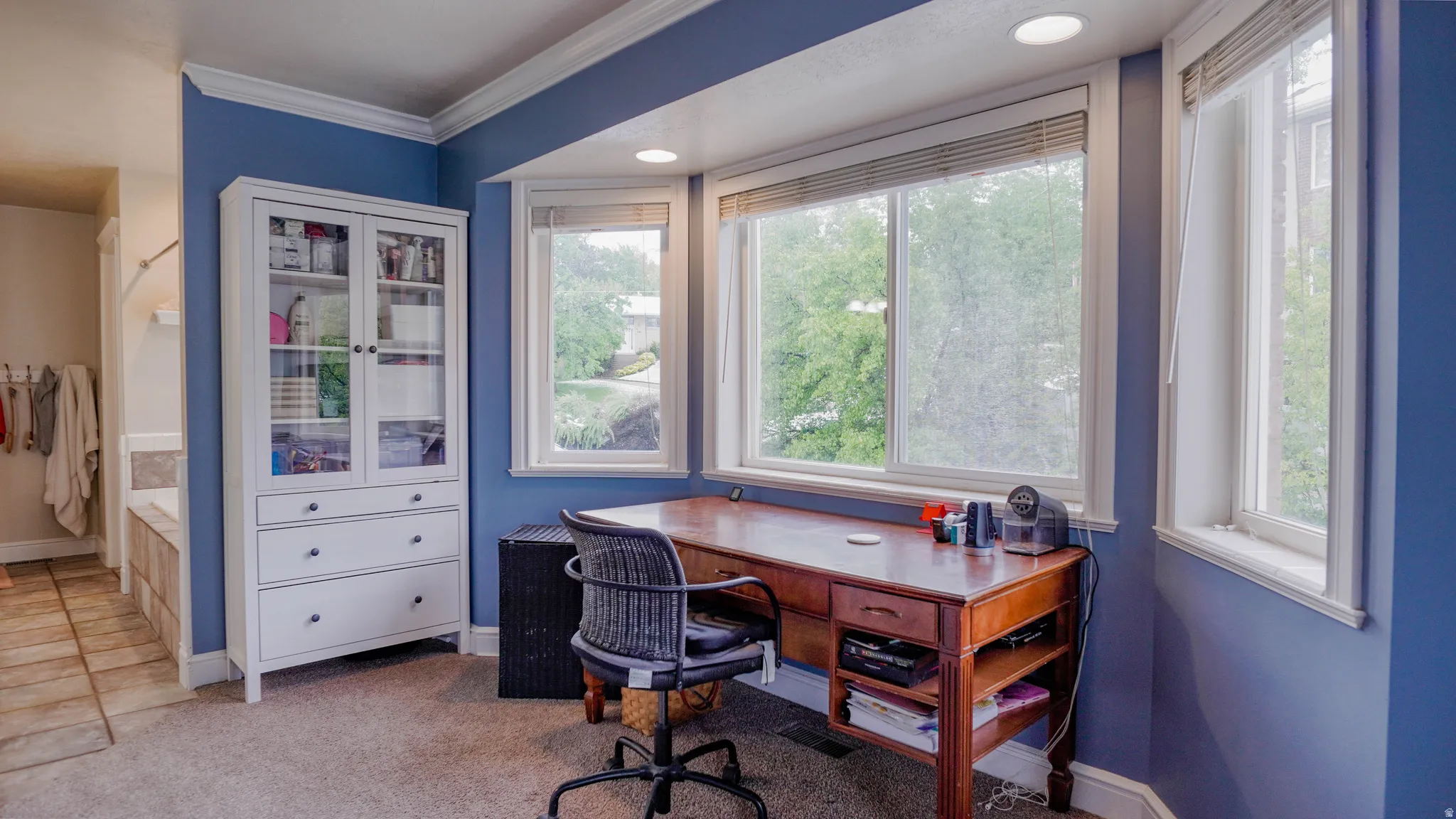 Large Primary Bedroom featuring Lots of Natural Light and Crown Molding with Room for Office Space