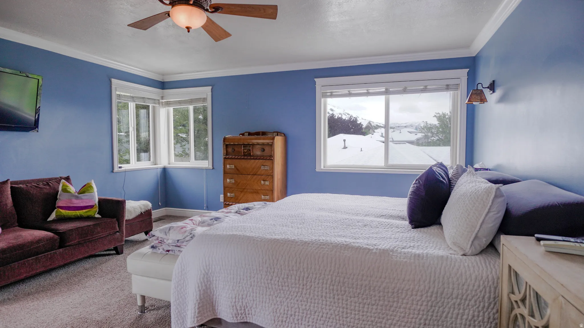 Large Primary Bedroom featuring Lots of Natural Light and crown molding