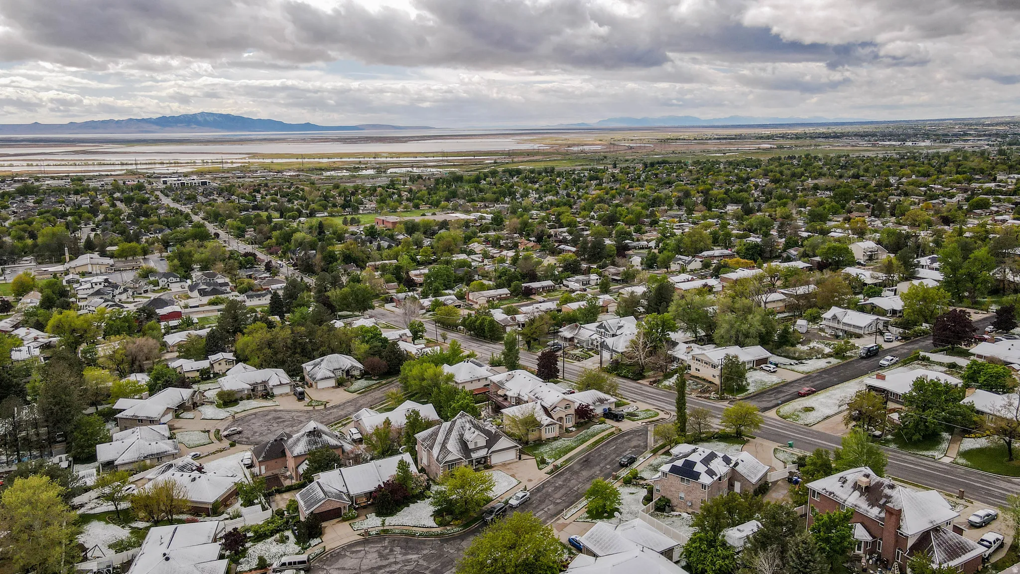 Aerial perspective of suburban area with a mountain backdrop