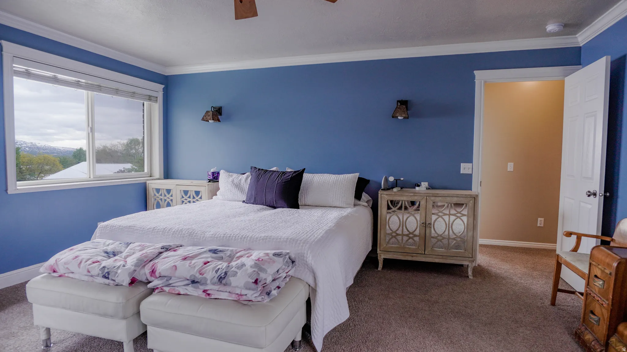 Large Primary Bedroom featuring Lots of Natural Light and crown molding