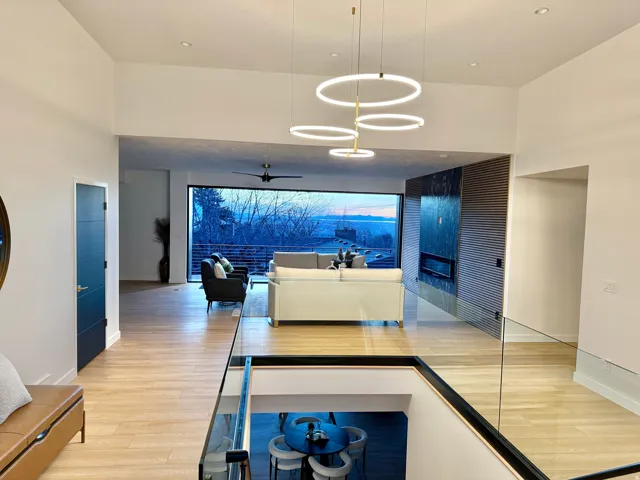 Hall featuring light wood-style floors and a high ceiling
