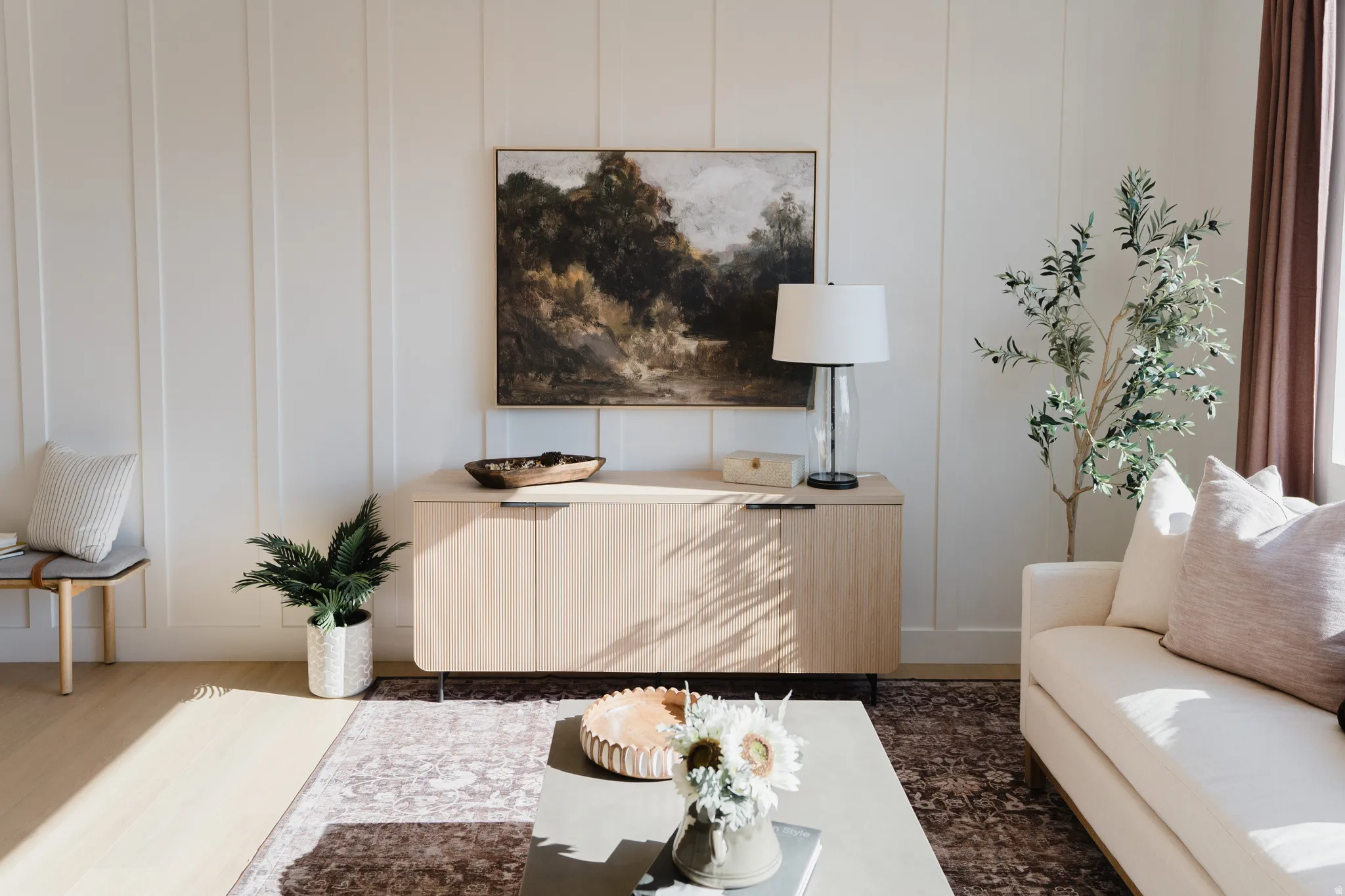 Sitting room featuring a decorative wall and wood finished floors