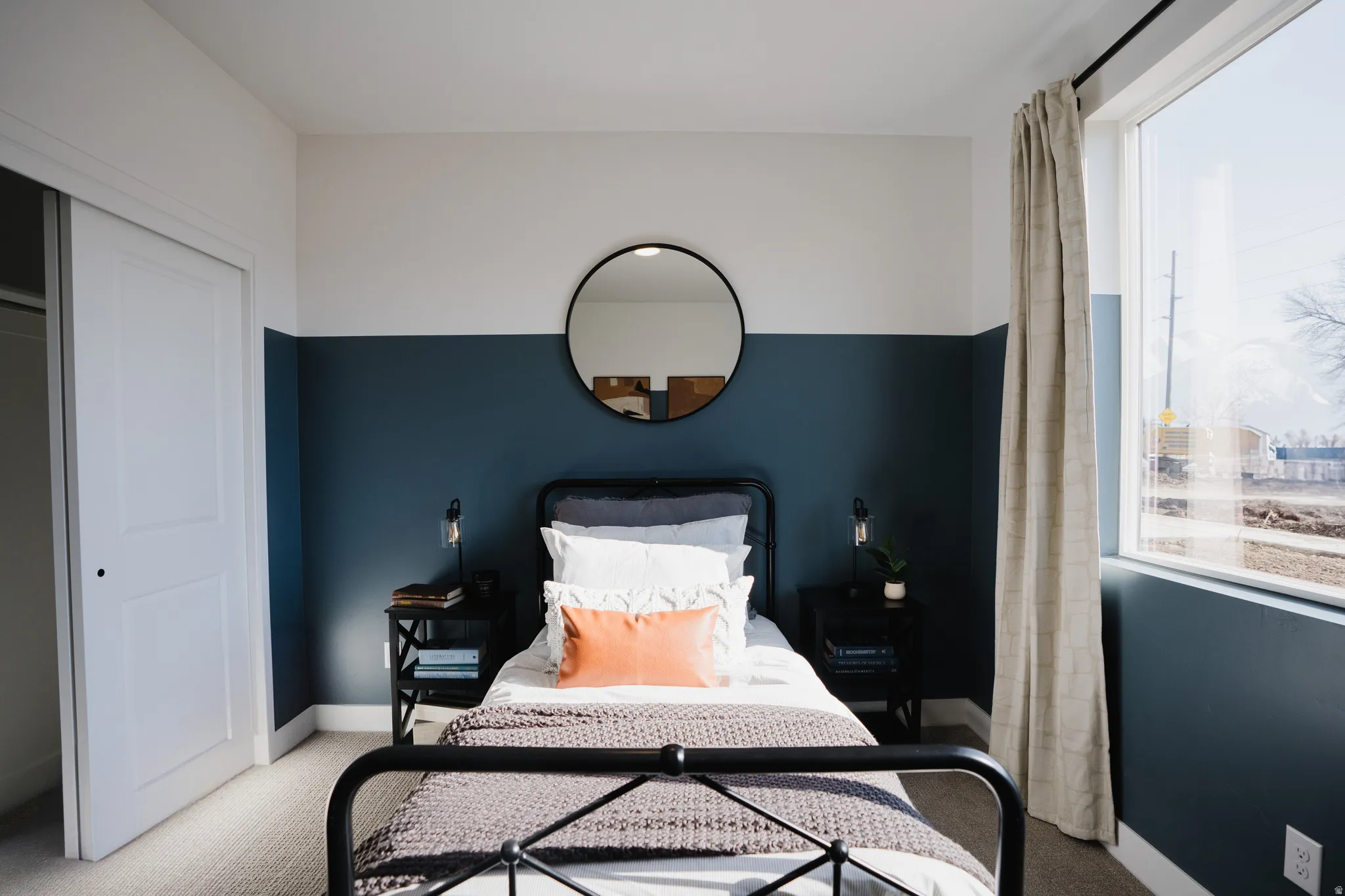 Bedroom with light carpet, multiple windows, and a closet