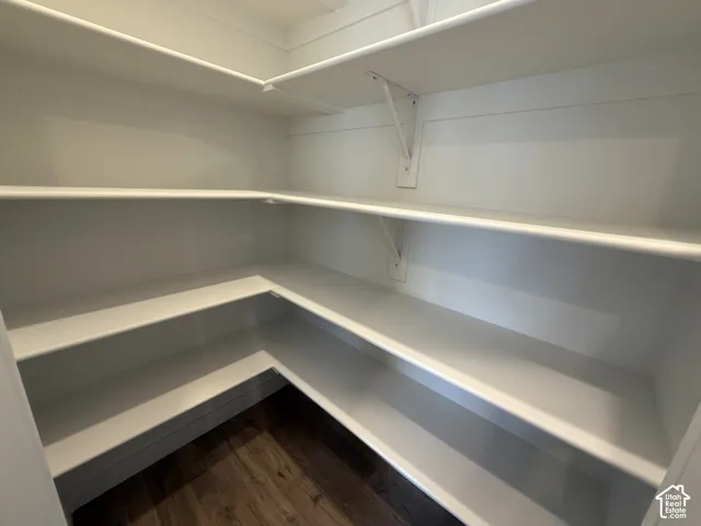 Built-in shelving with L-shaped configuration and wood-finish flooring