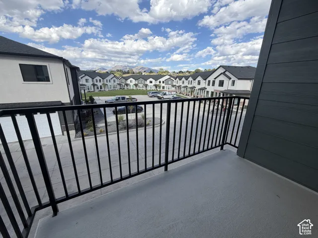Balcony featuring a black metal railing and a painted concrete surface